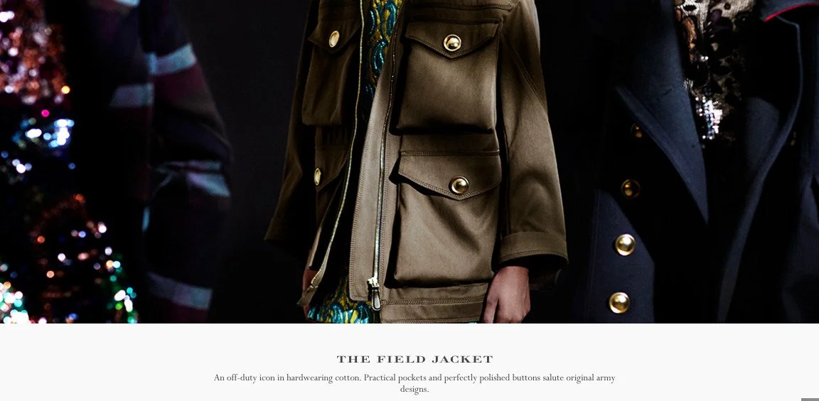 Close-up of two people wearing jackets, one gold-colored and one dark, with a decorated Christmas tree in the background.