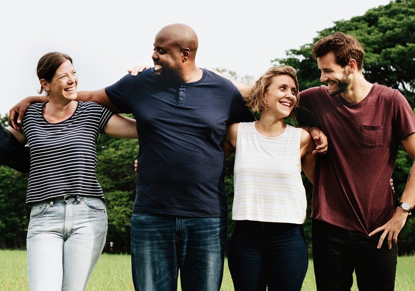 Group of people hugging each other in the park