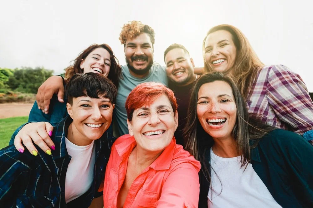 Group of people with diverse backgrounds smiling and looking at the camera