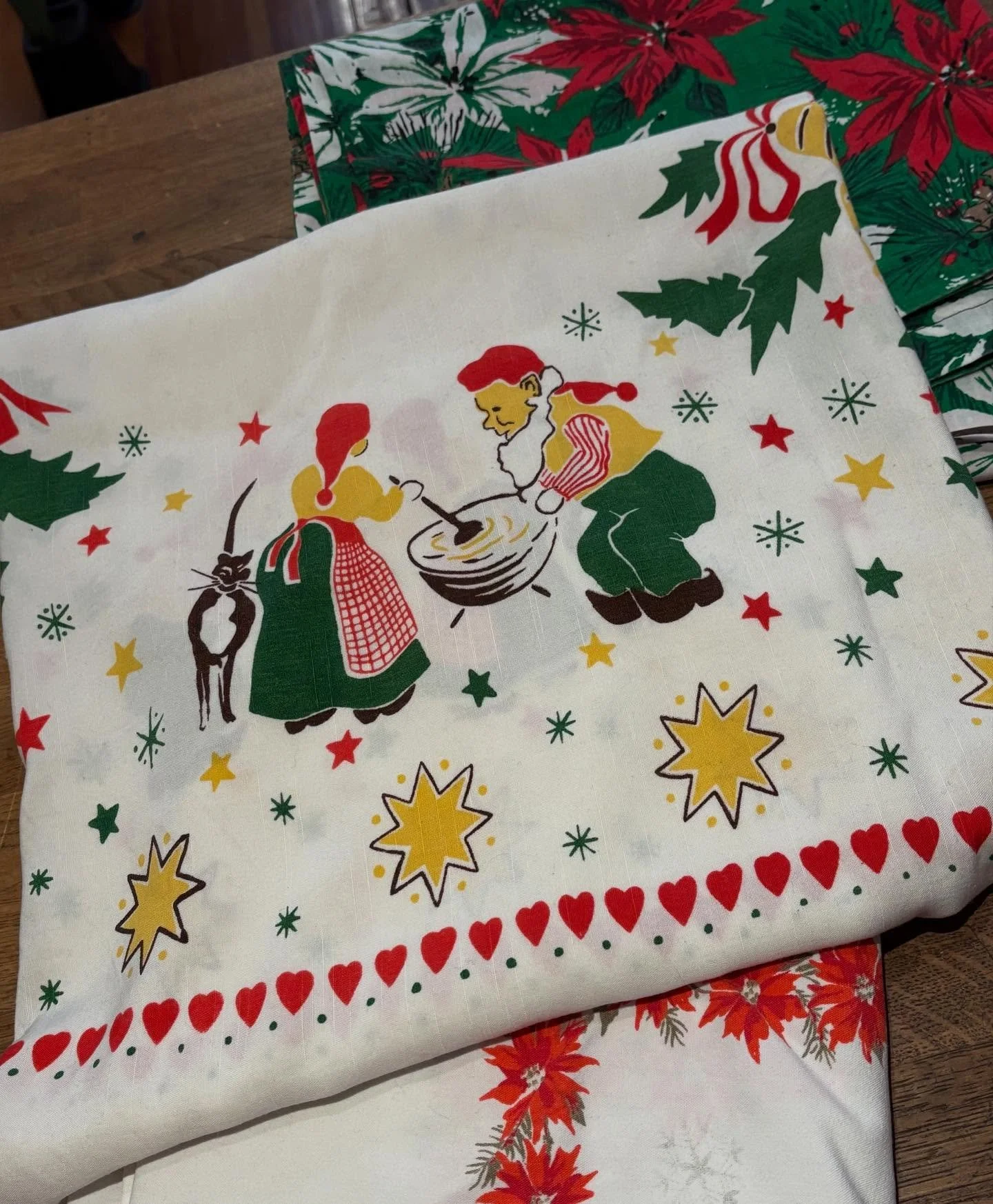 My favorite Christmas tablecloth this year!  This likely #norweigan #scandinavian tablecloth features snowflakes, stars, holly and bells, porridge and a CAT!  A #tuxedocat to be specific!  Measures about 4' square. Soft rayon. $35
