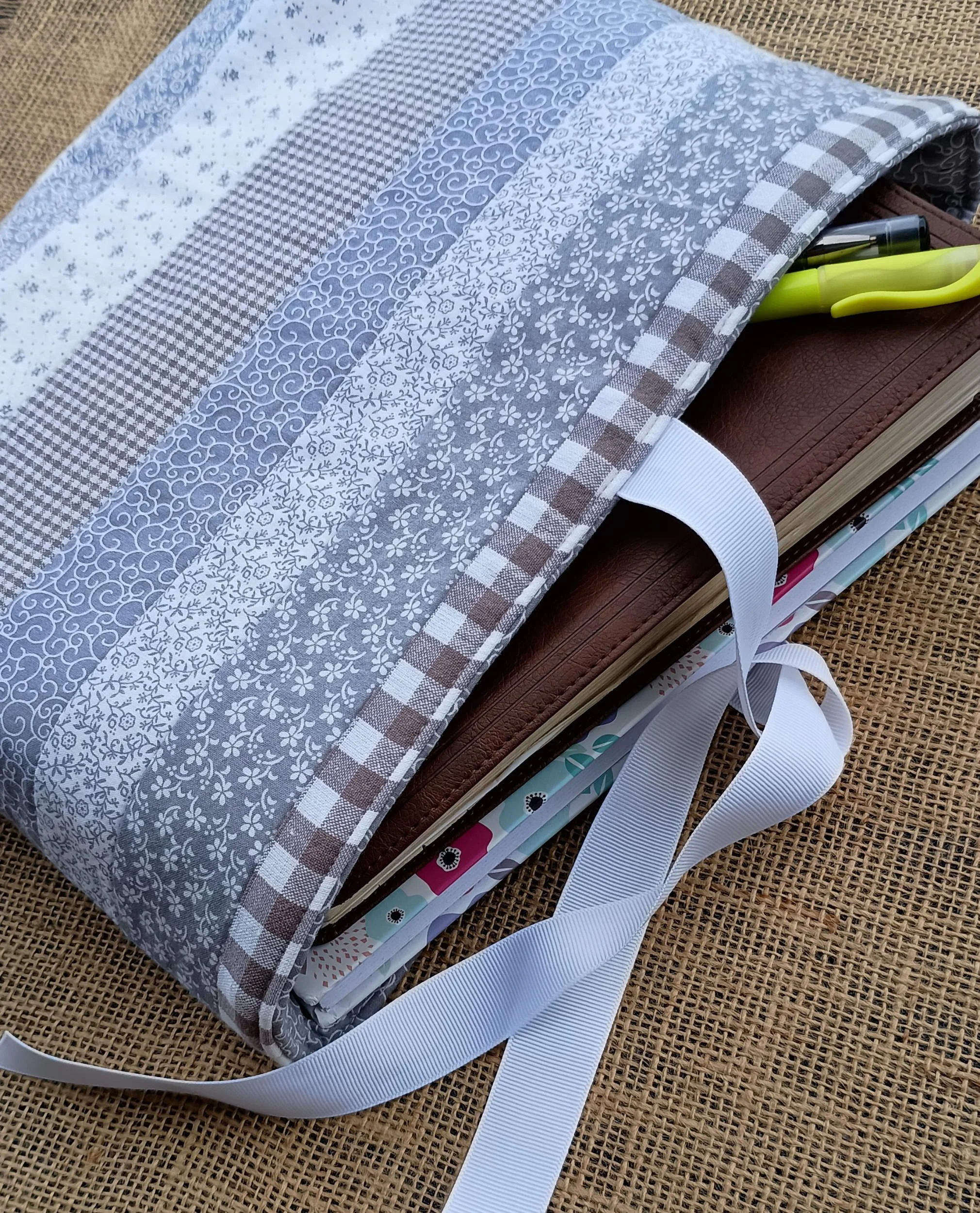 A quilted Bible Sleeve made from gray and white print fabrics