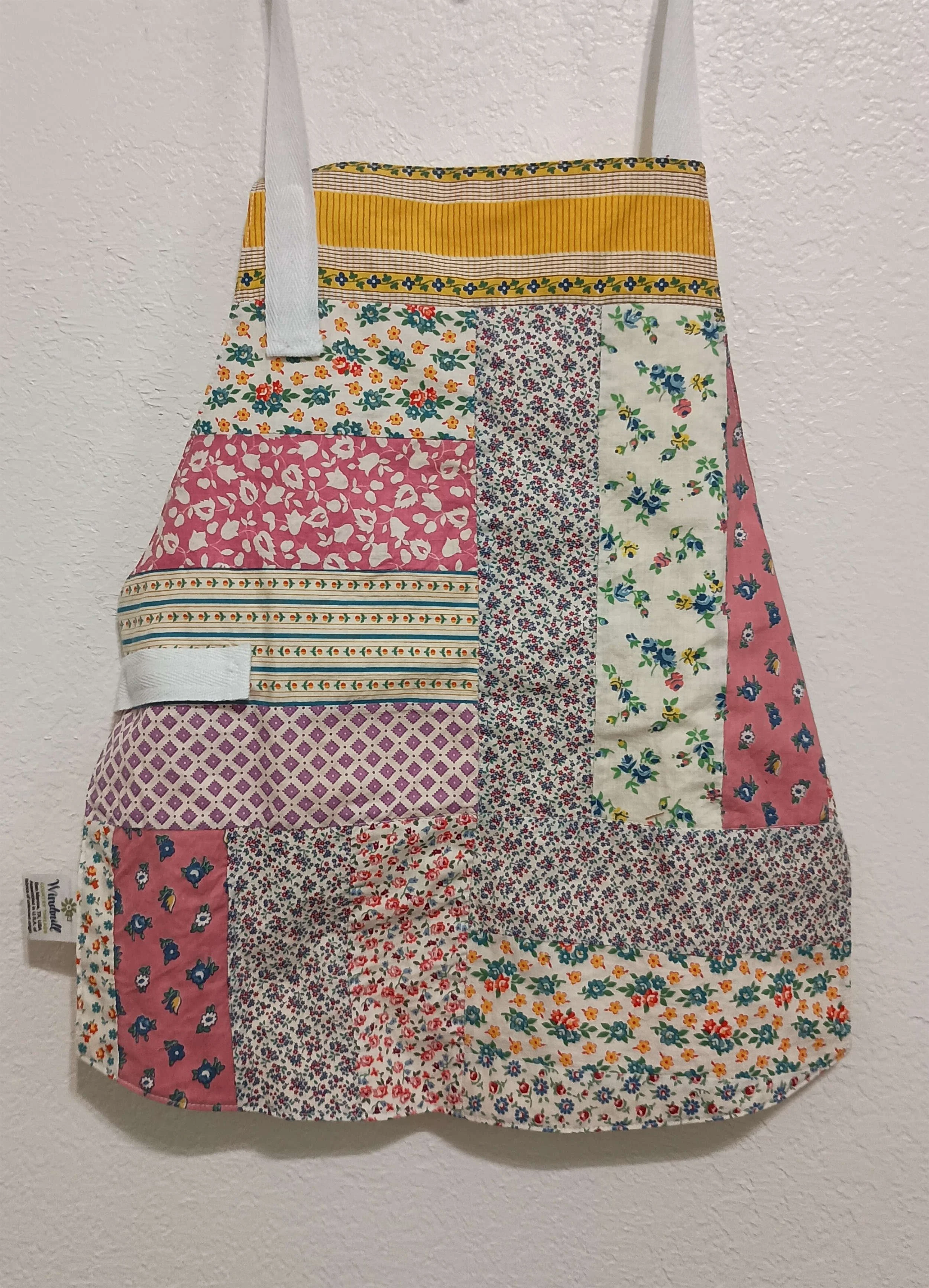 A child sized apron made from an antique quilt top.