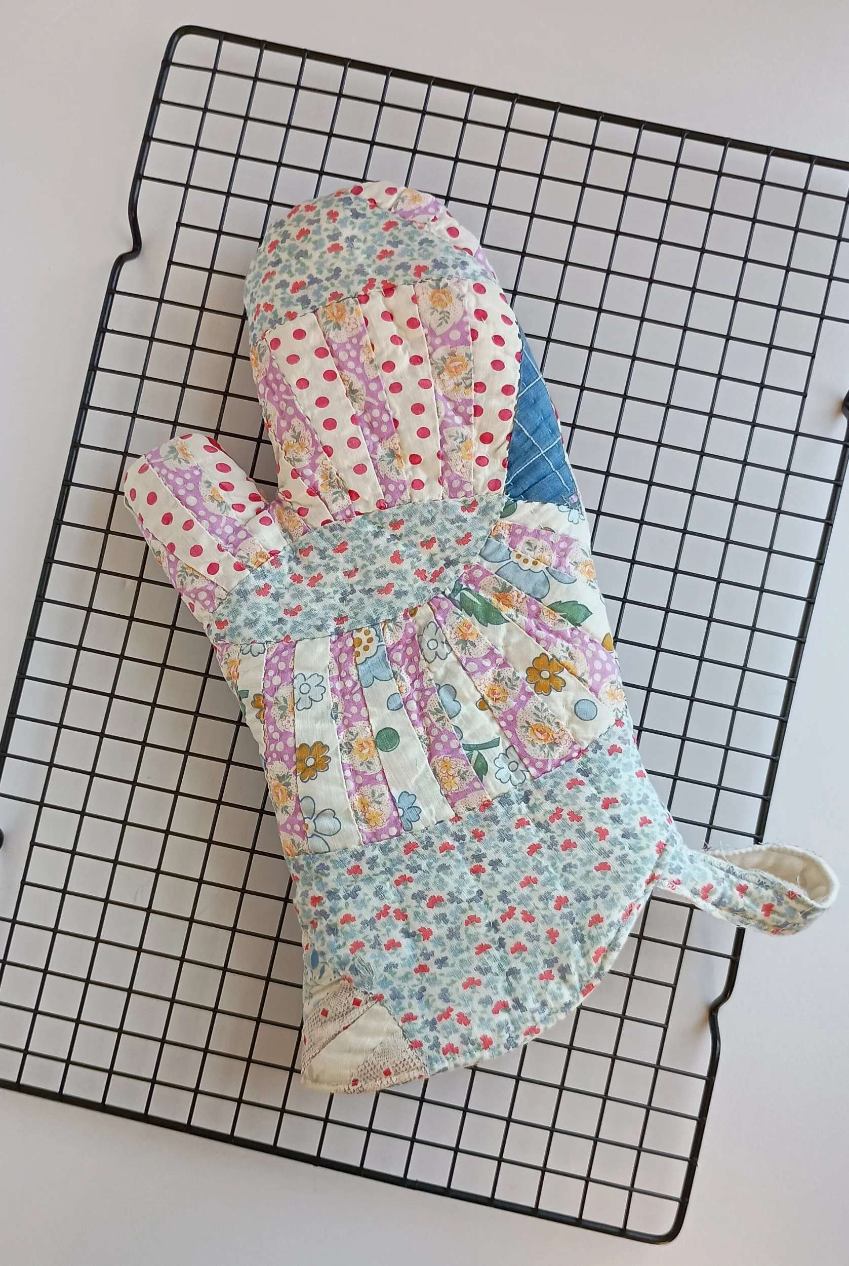 An oven mitt made from an antique quilt