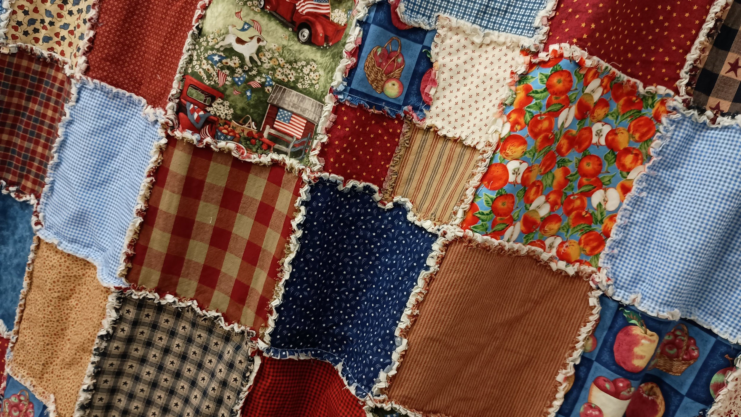 A patchwork shower curtain featuring Americana themed squares and colors