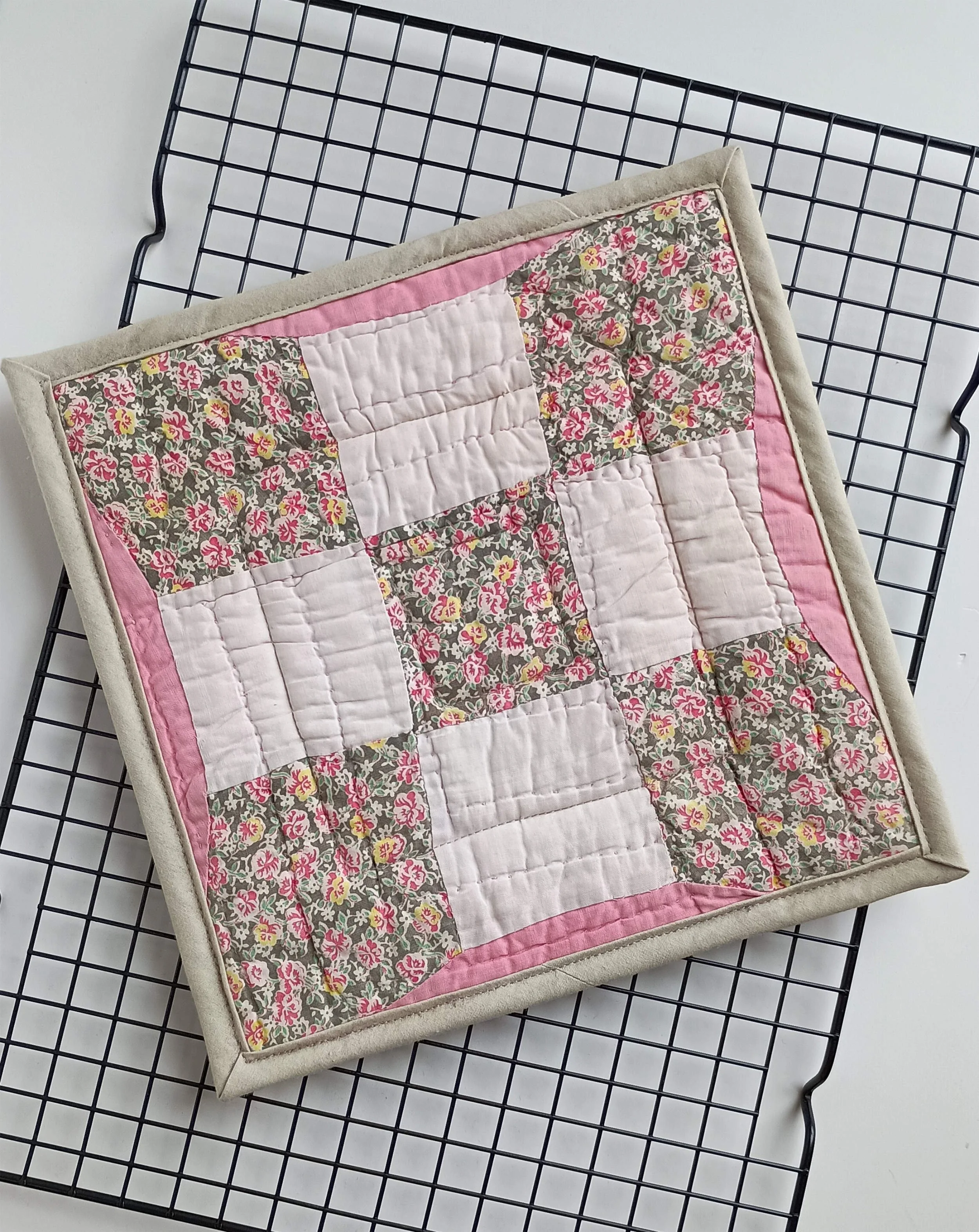 A hot pad made from an antique quilt square