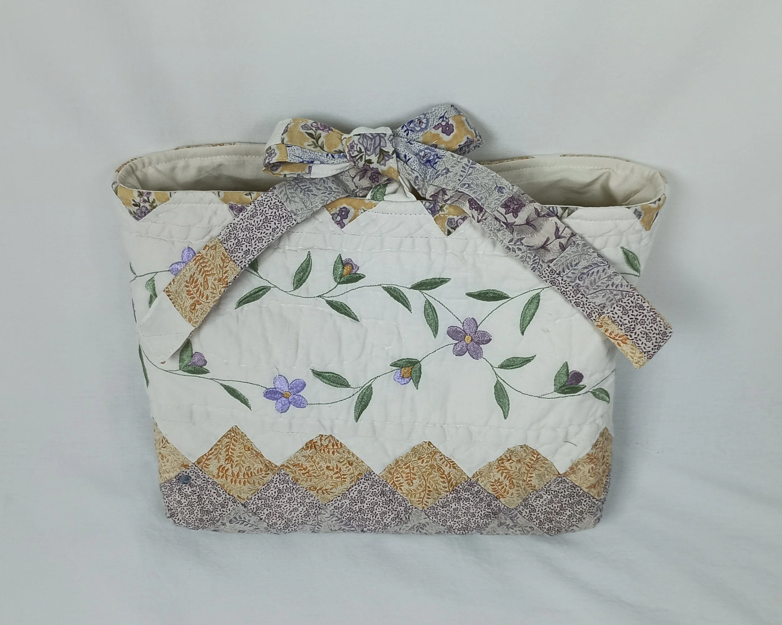 A large Bible sleeve with Lavender Floral Embroidery made from a vintage quilt