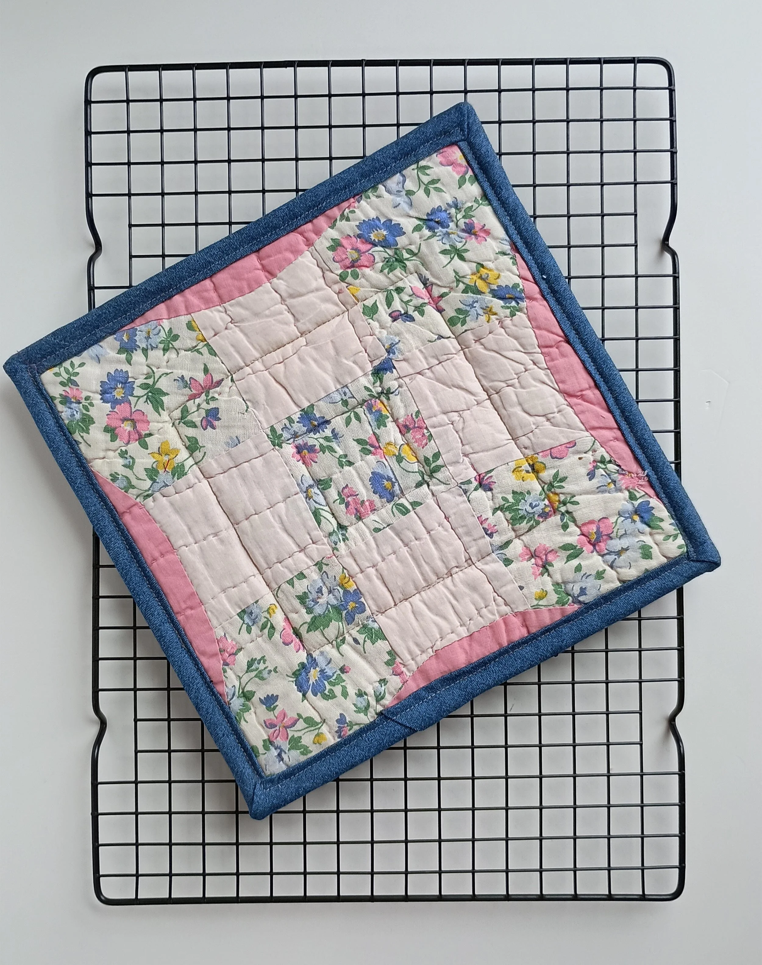 A hot pad made from an antique quilt square