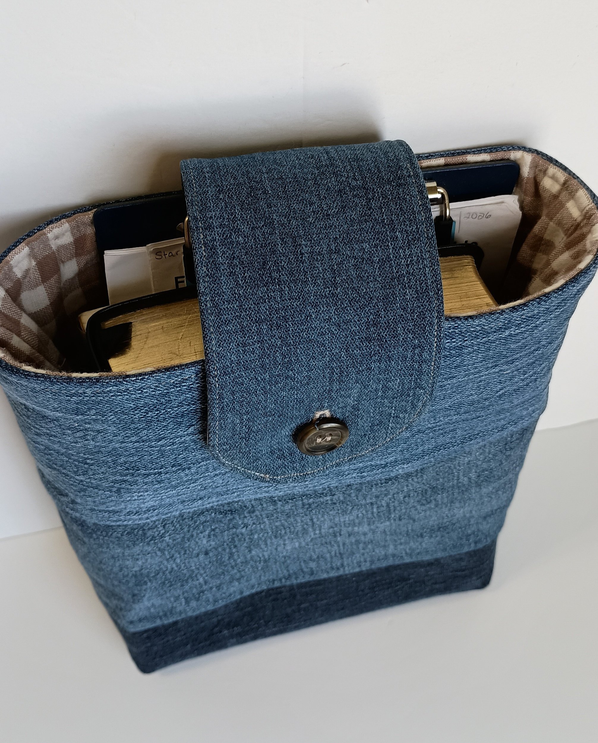 A vertical pouch for holding a Bible or book made from upcycled denim.
