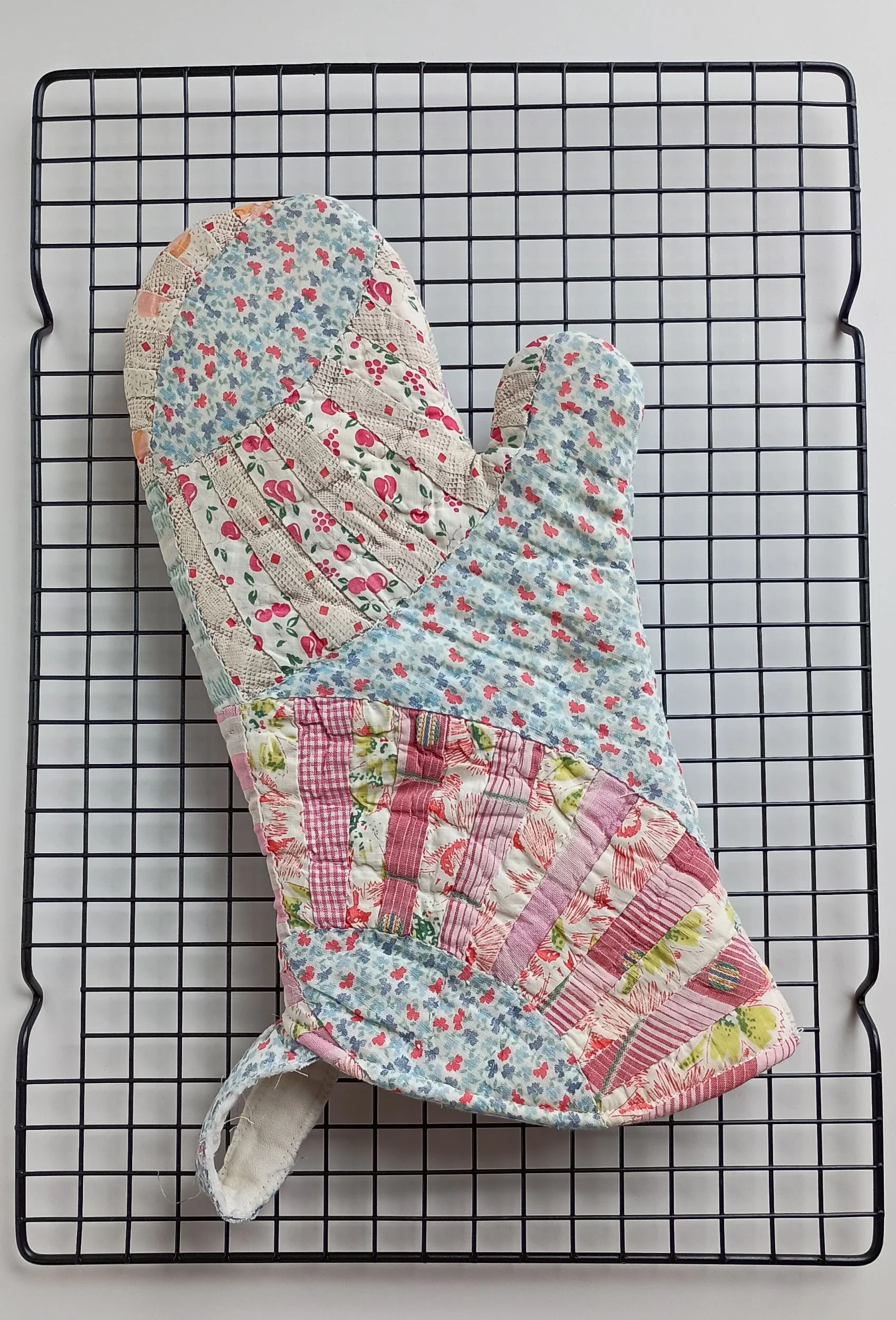 An oven mitt made from an antique quilt
