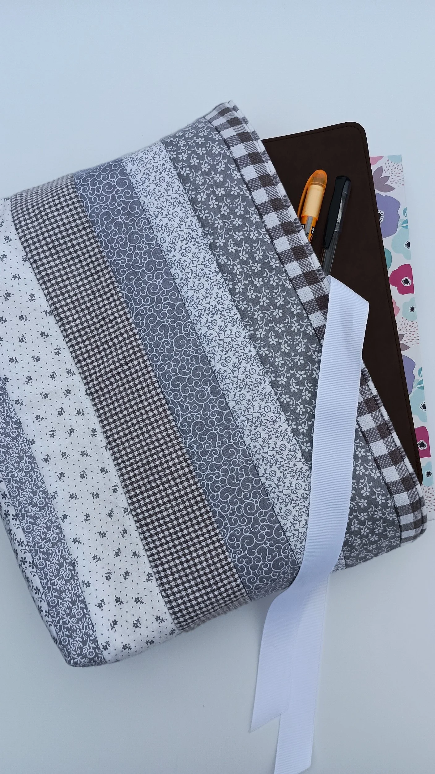 A quilted Bible Sleeve made from gray and white print fabrics