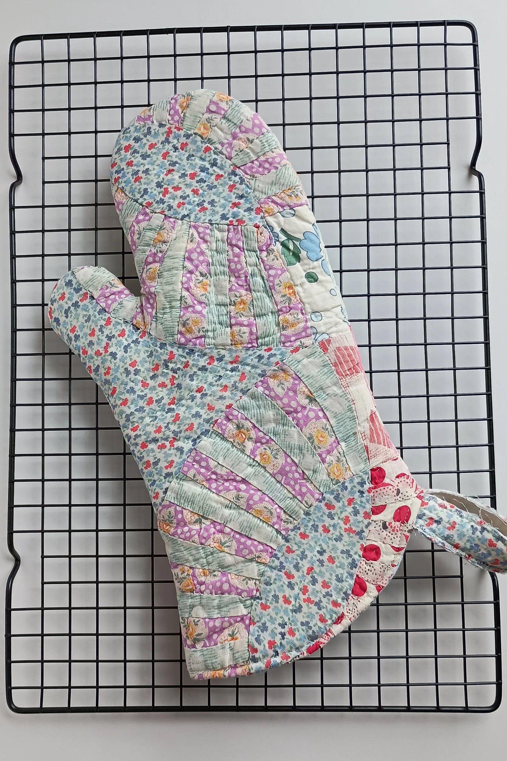 An oven mitt made from an antique quilt