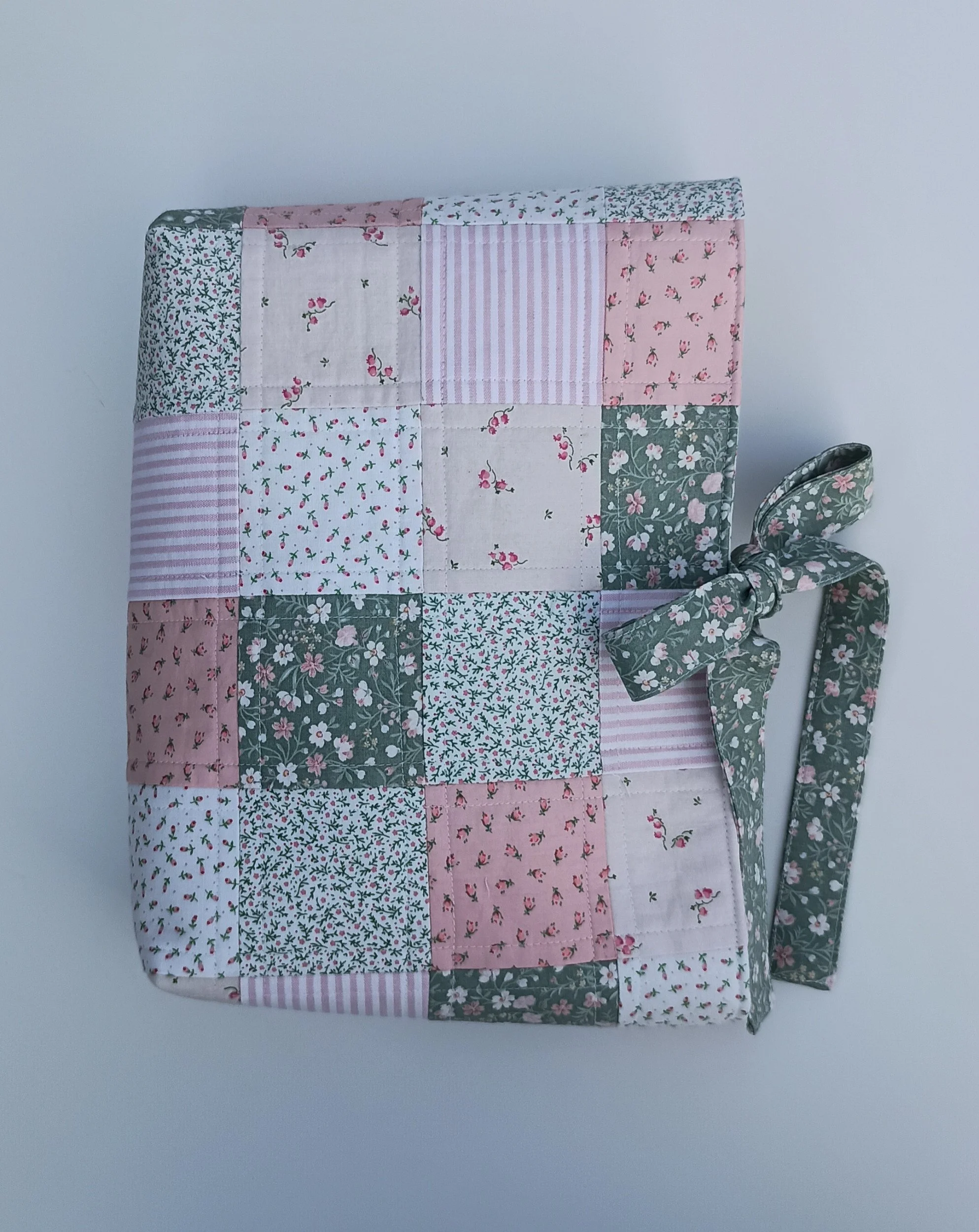A quilted Bible Sleeve made from pink and green fabrics