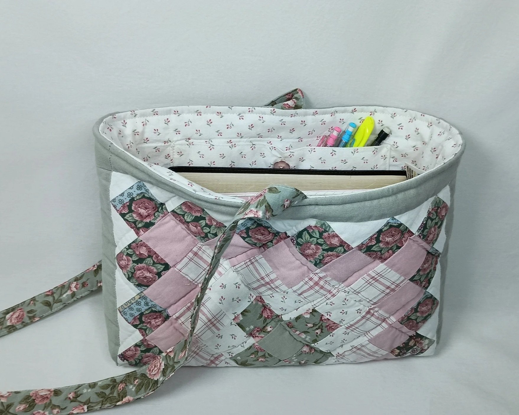 A Bible sleeve made from a pink and sage green patchwork quilt