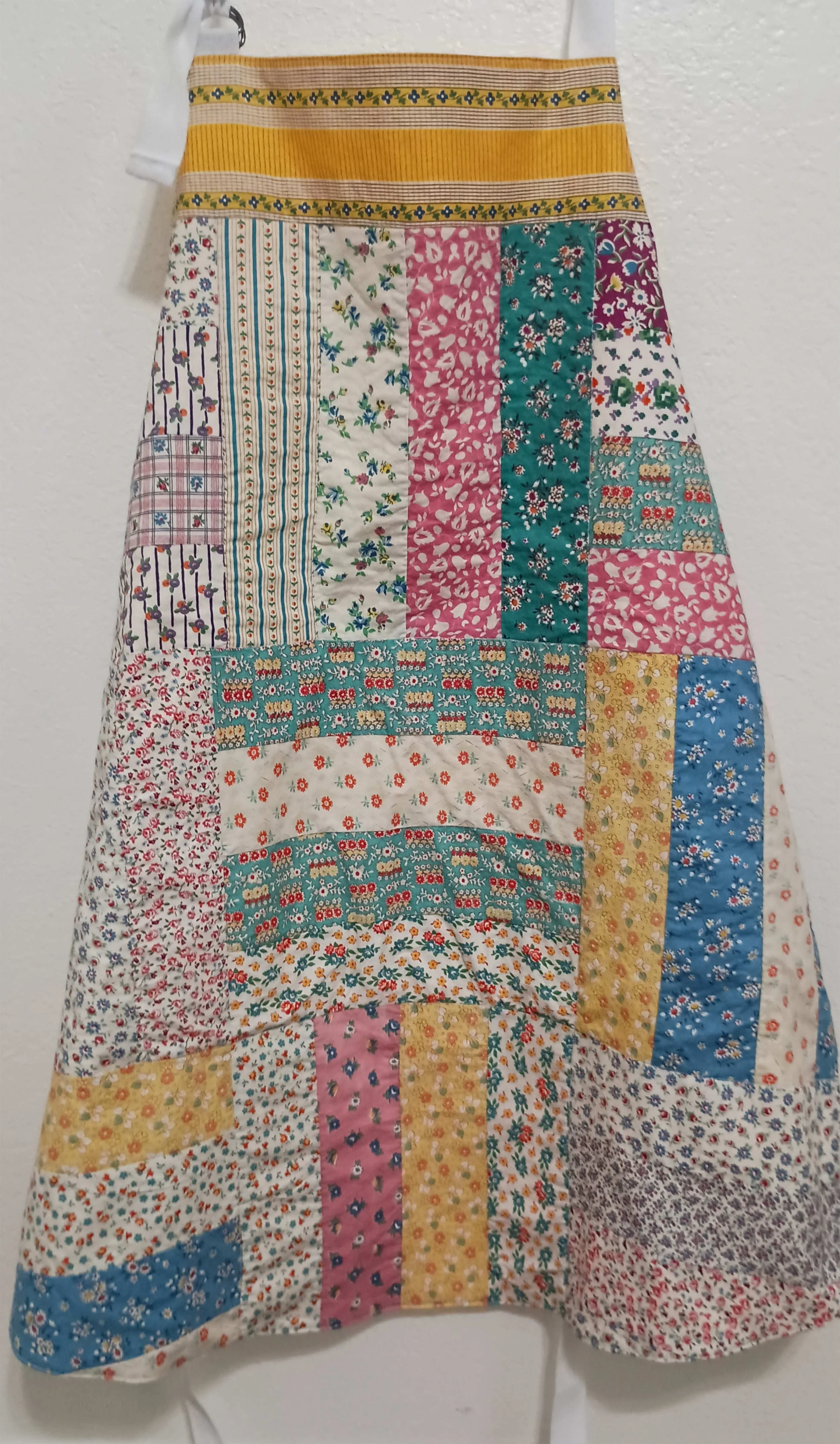 An adult sized apron made from an antique quilt top.