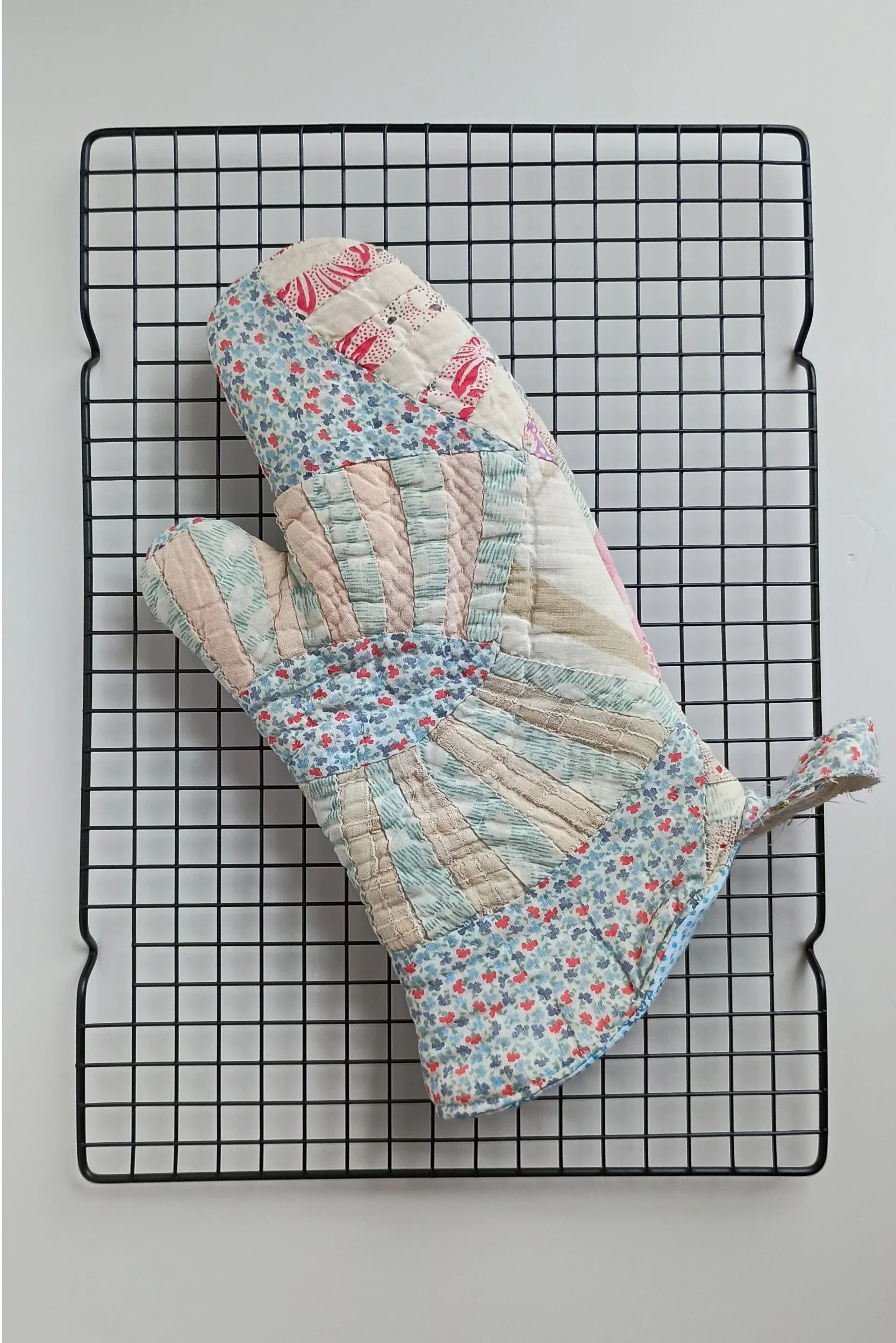 An oven mitt made from an antique quilt
