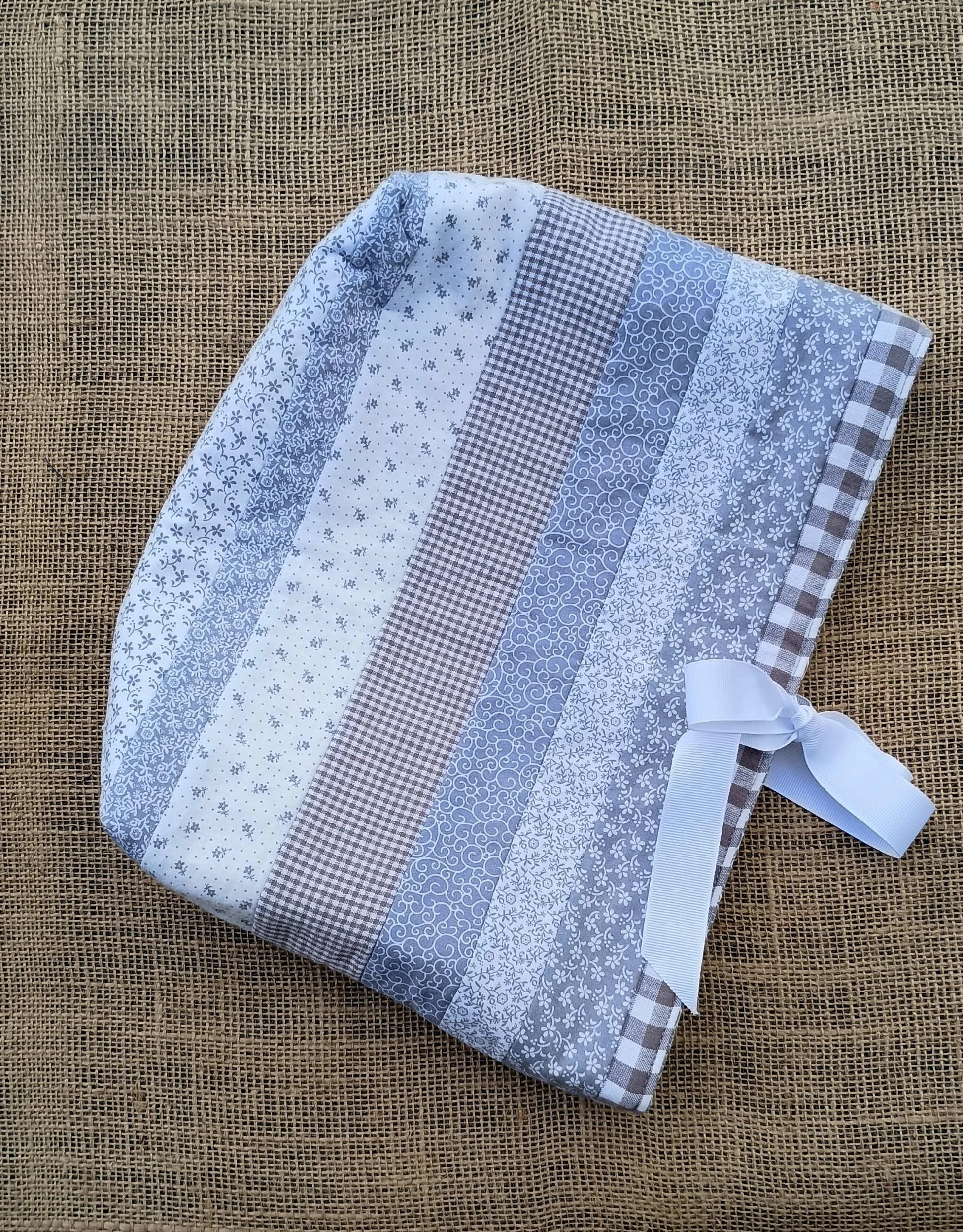 A quilted Bible Sleeve made from gray and white print fabrics