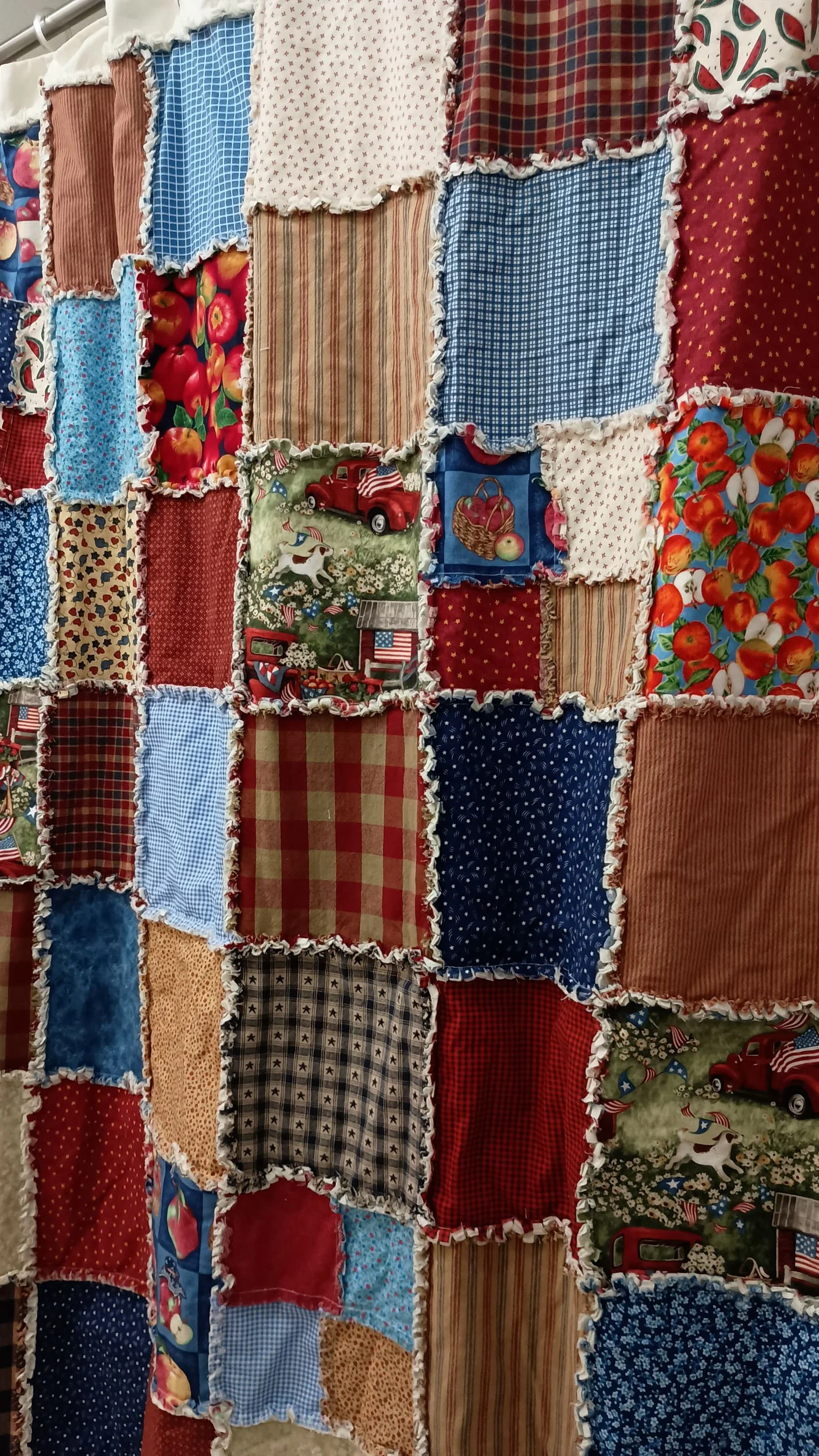 A patchwork shower curtain featuring Americana themed squares and colors