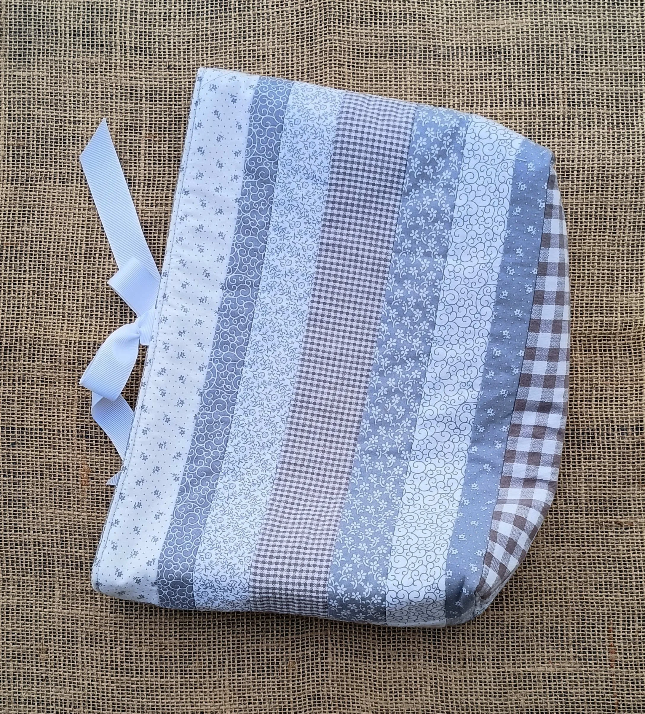 A quilted Bible Sleeve made from gray and white print fabrics