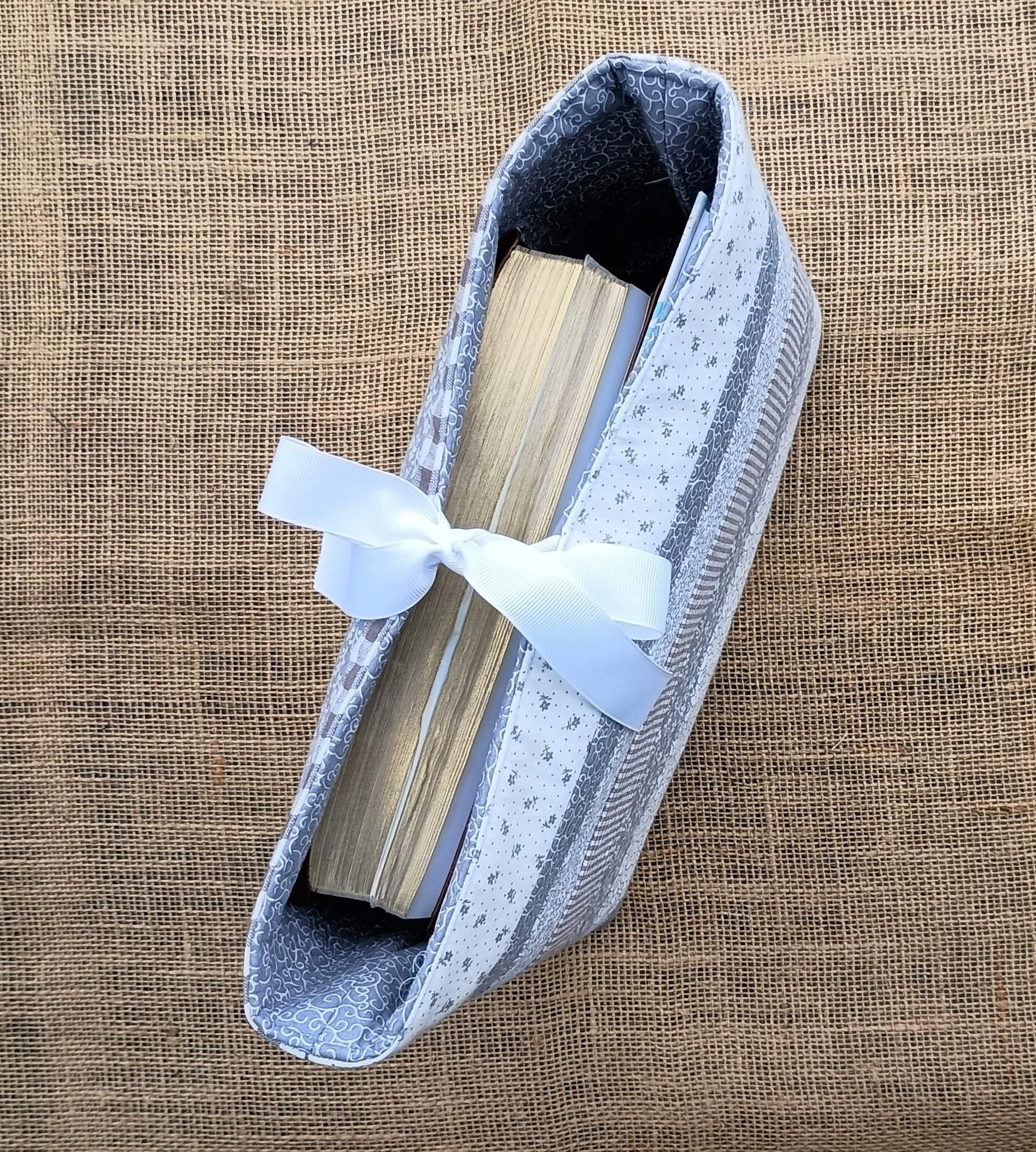 A quilted Bible Sleeve made from gray and white print fabrics