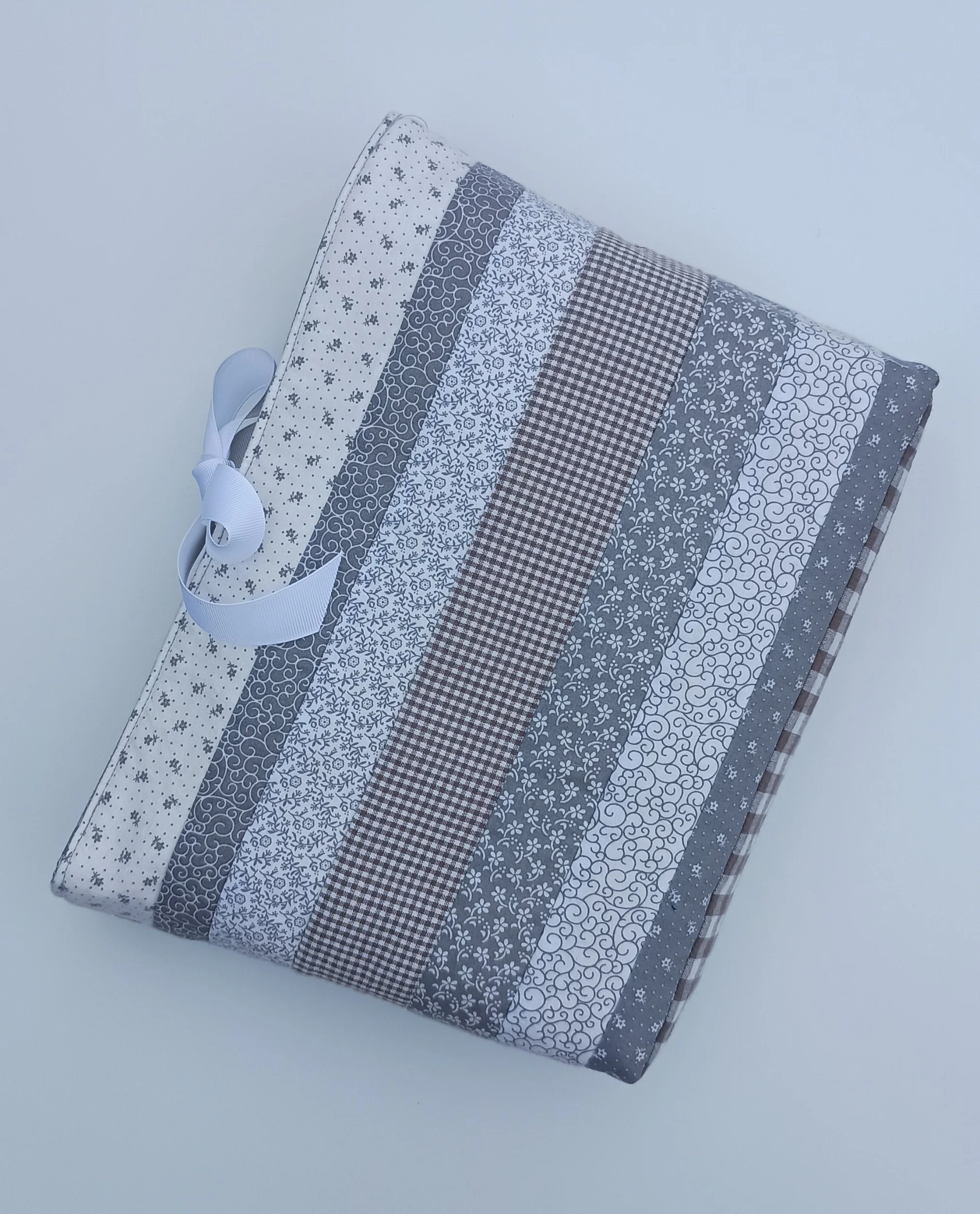 A quilted Bible Sleeve made from gray and white print fabrics