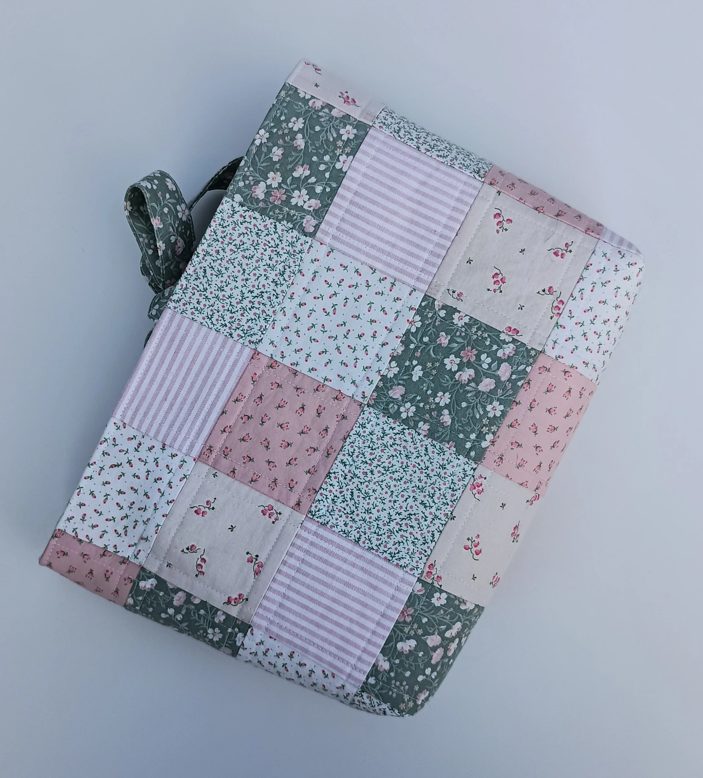 A quilted Bible Sleeve made from pink and green fabrics