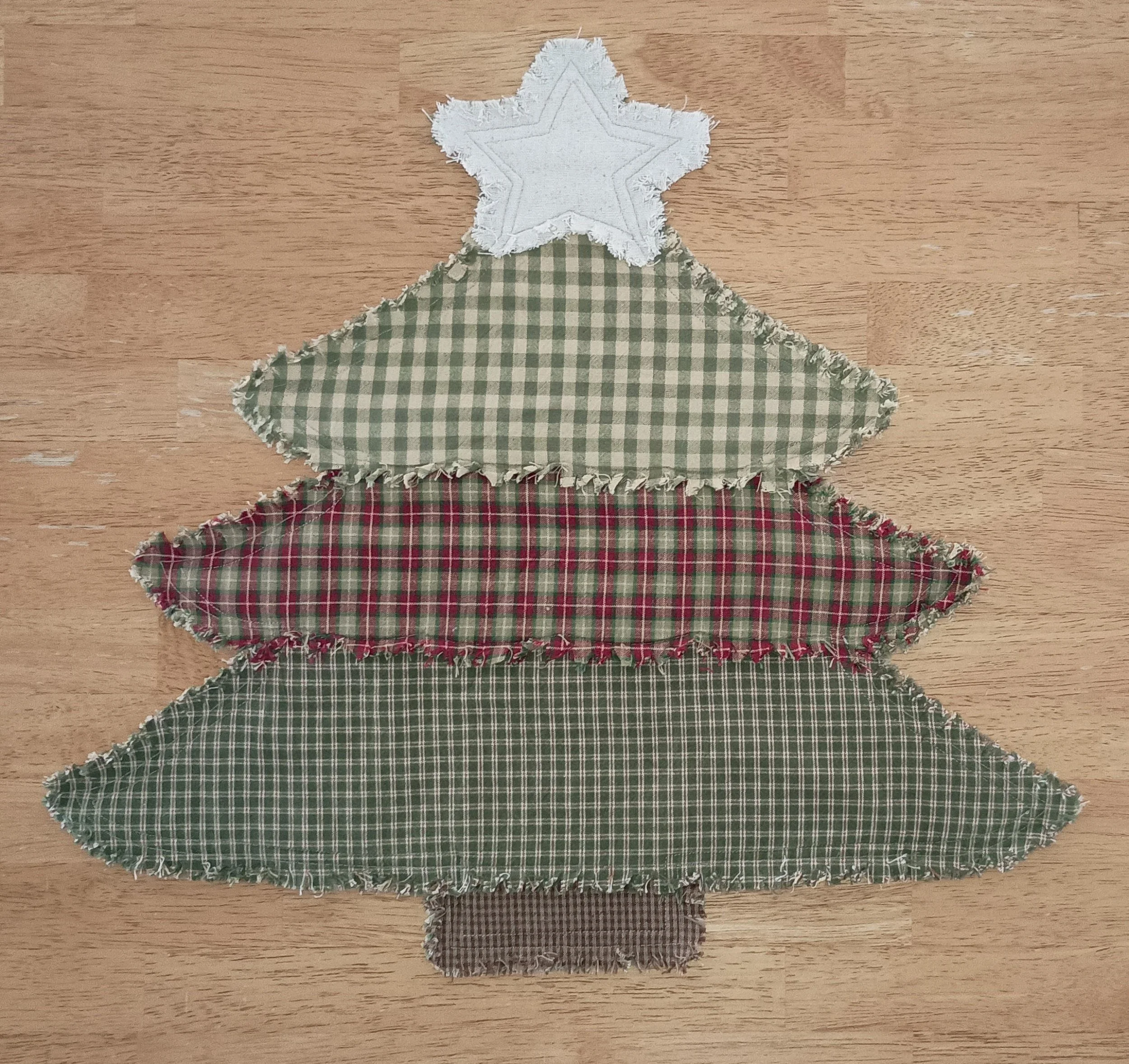 Christmas Tree Placemat made with various sage green and rustic red plaid fabrics