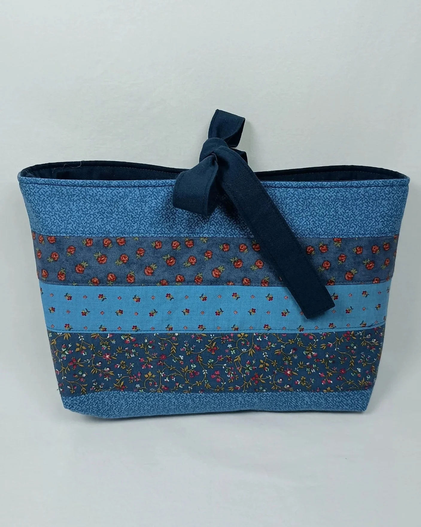 A bible sleeve made from coordinating strips of blue floral fabrics