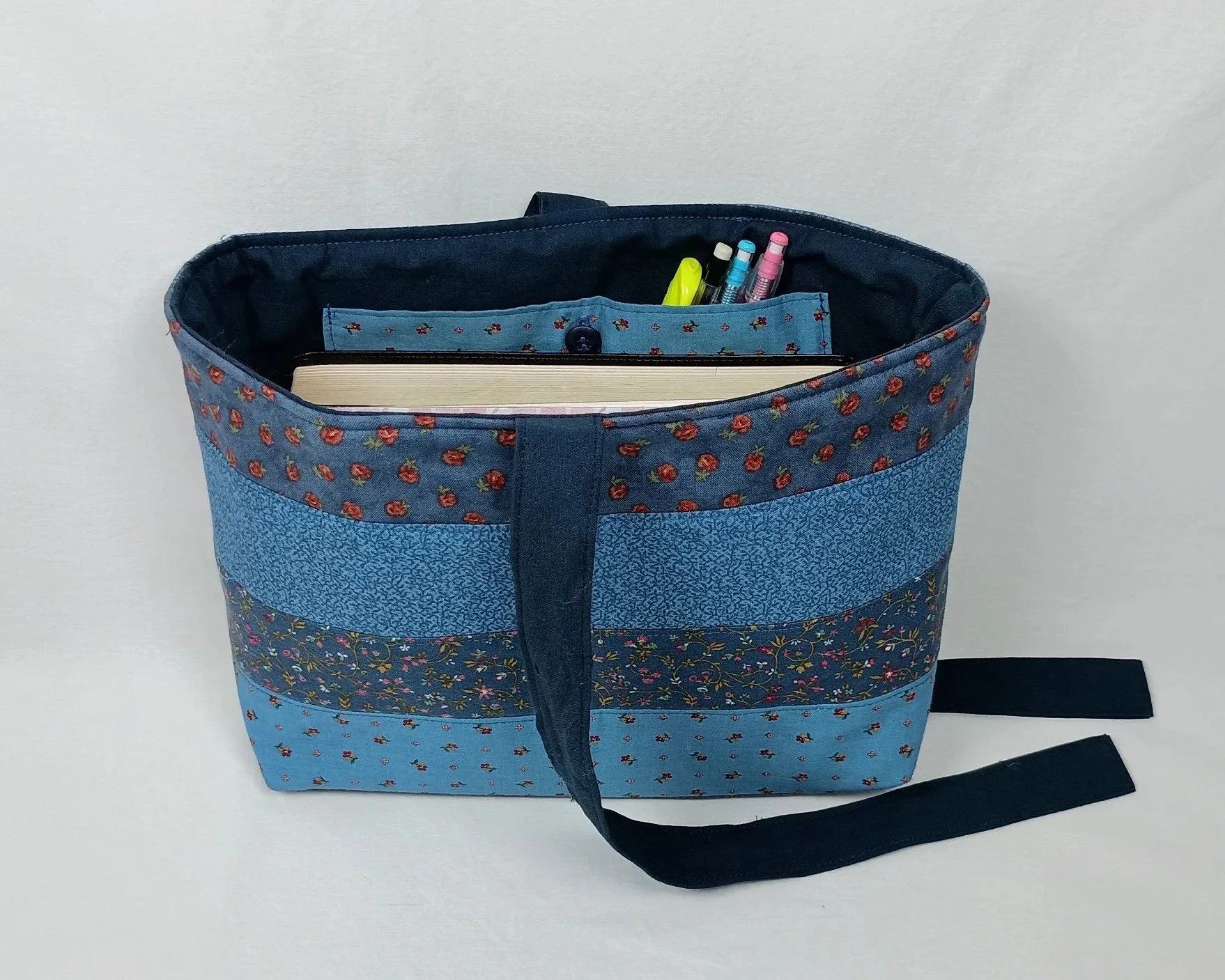 A bible sleeve made from coordinating strips of blue floral fabrics