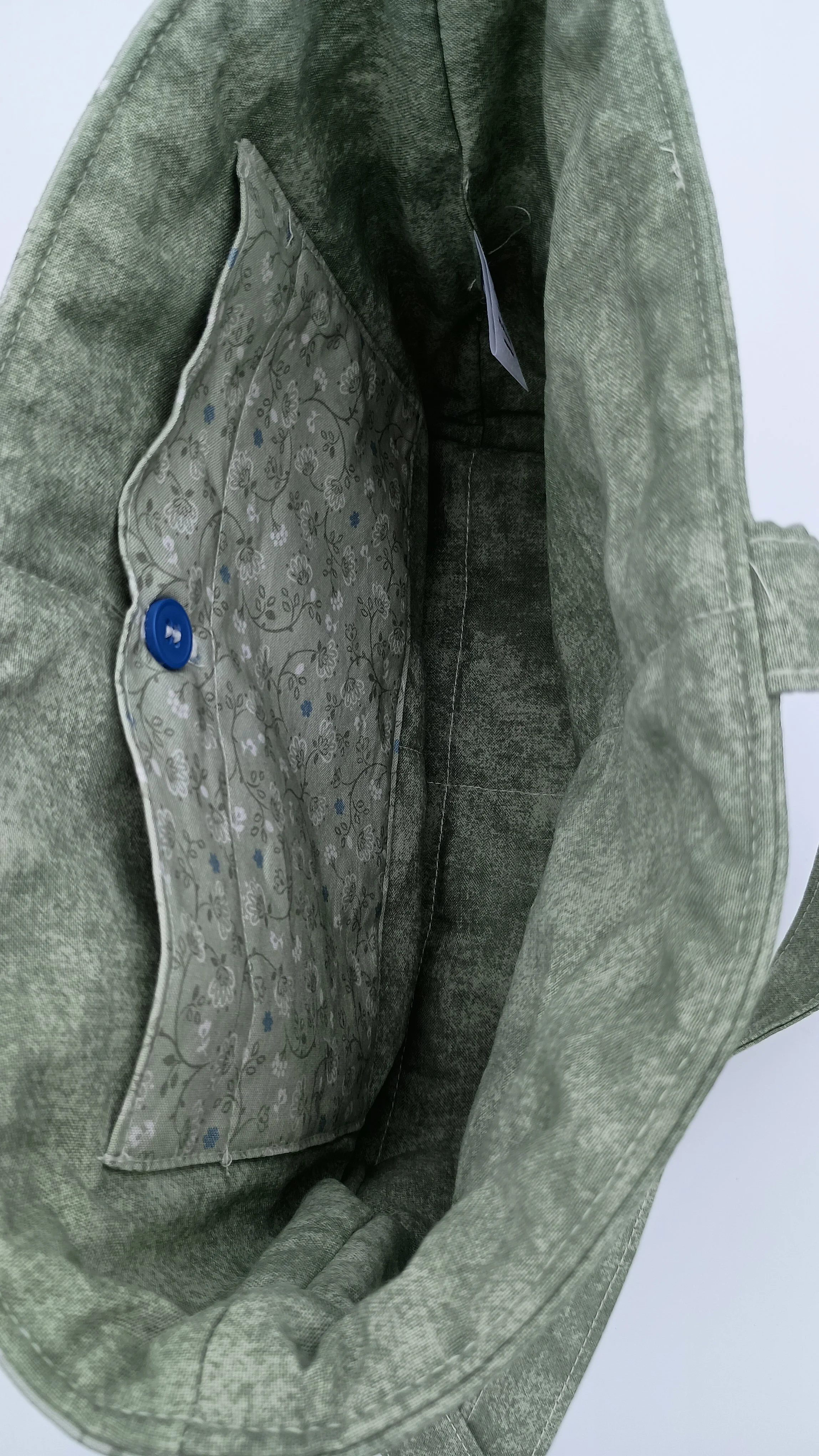 A quilted Bible Sleeve made from sage, blue, and beige fabrics