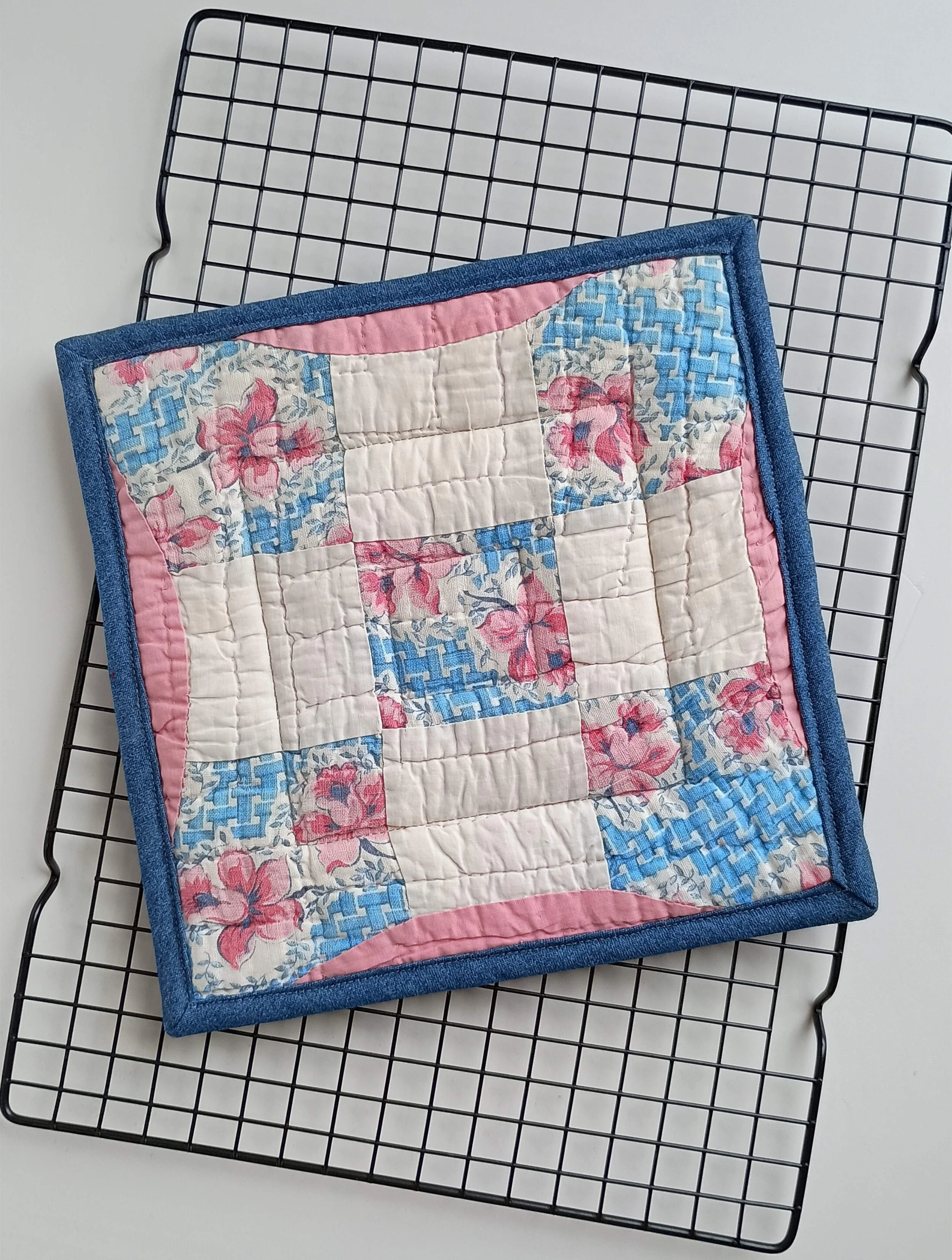 A hot pad made from an antique quilt square