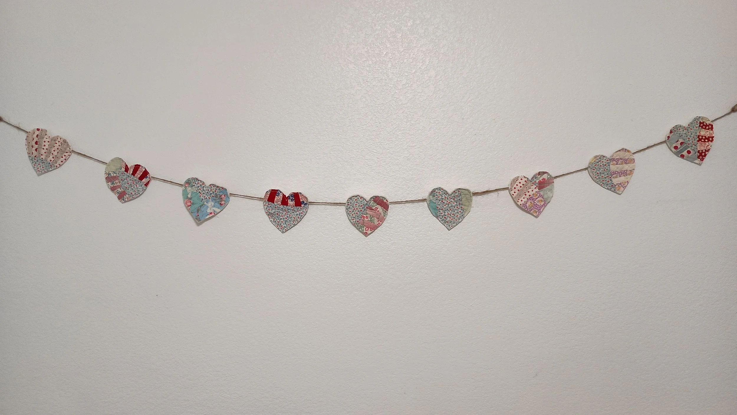 A garland made of jute rope and hearts cut from an antique quilt