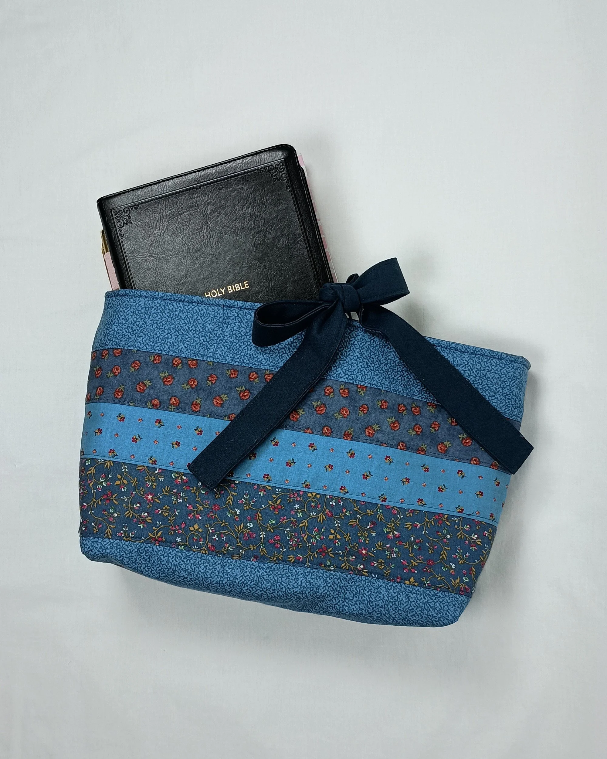 A bible sleeve made from coordinating strips of blue floral fabrics
