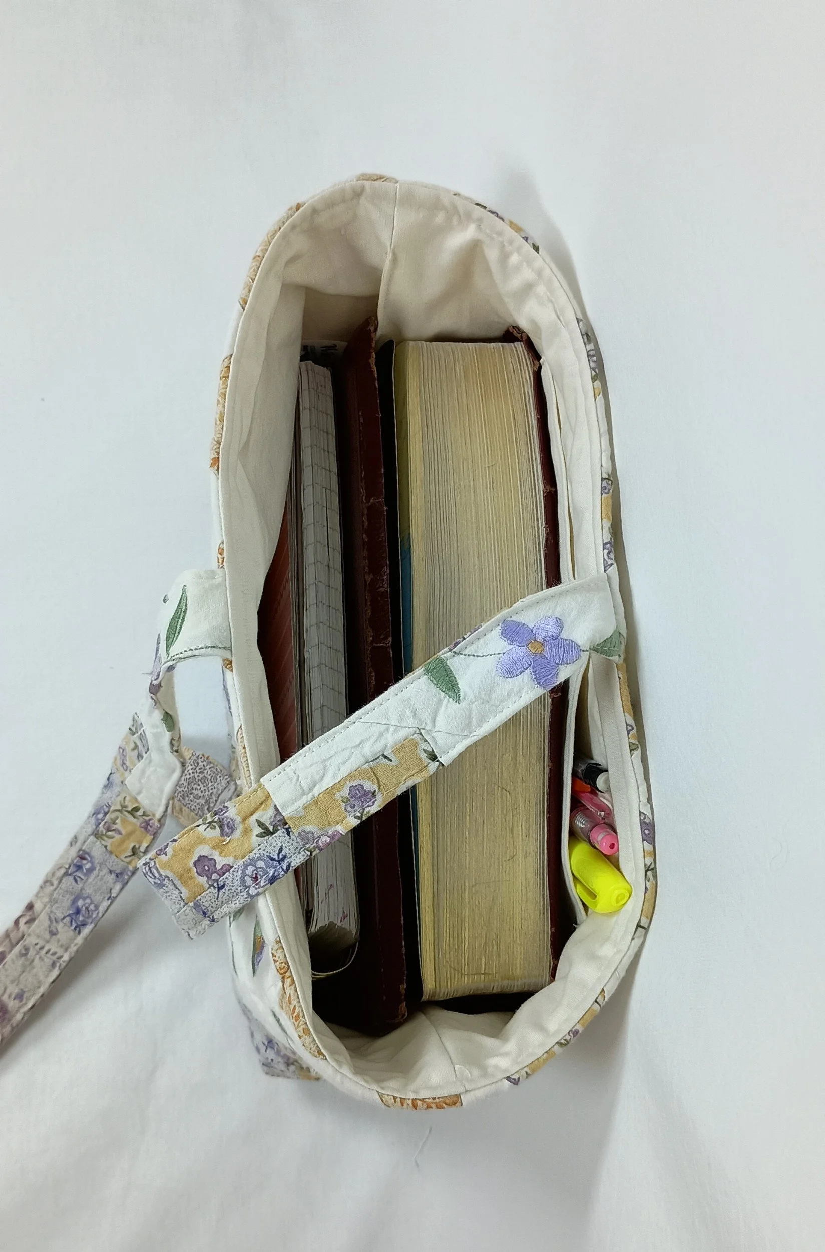 An inside view of a large Bible sleeve with Lavender Floral Embroidery made from a vintage quilt