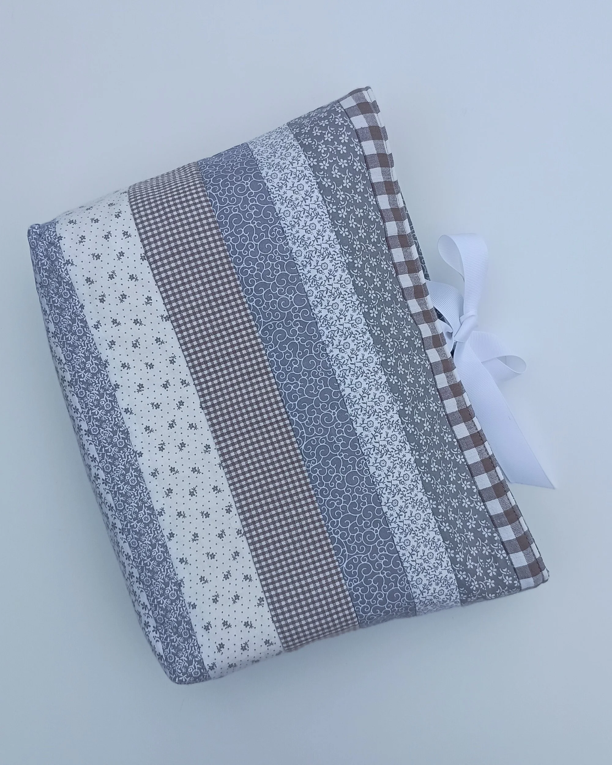 A quilted Bible Sleeve made from gray and white print fabrics
