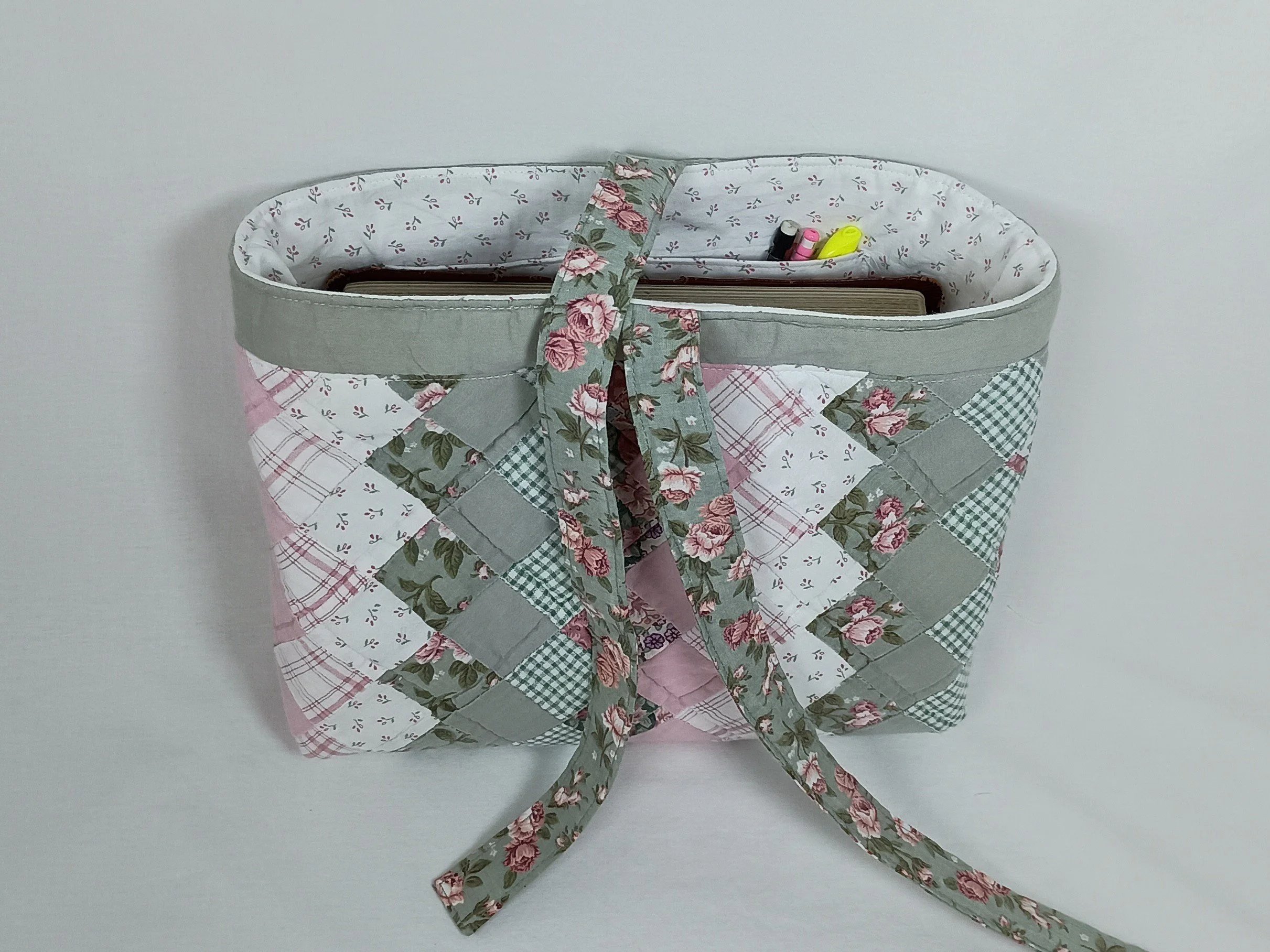 A Bible sleeve made from a pink and sage green patchwork quilt