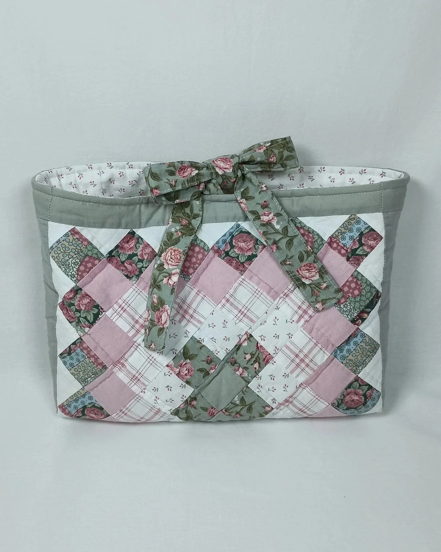 A Bible sleeve made from a pink and sage green patchwork quilt