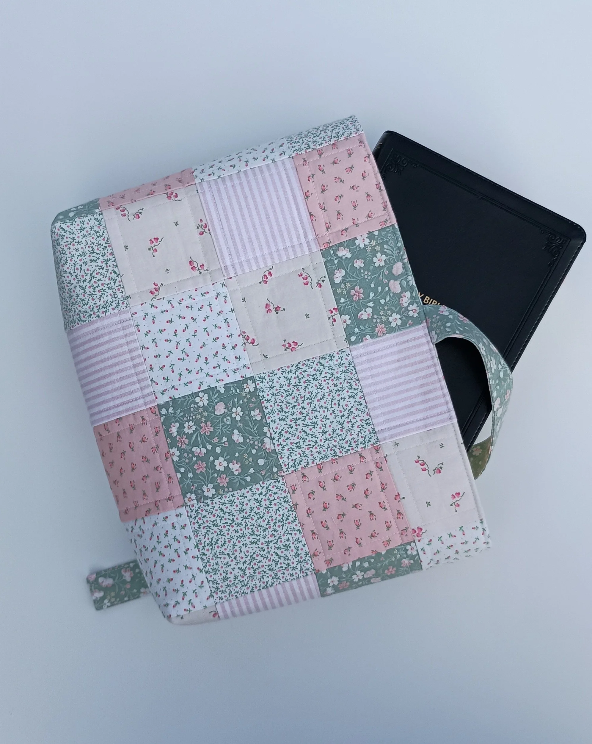 A quilted Bible Sleeve made from pink and green fabrics
