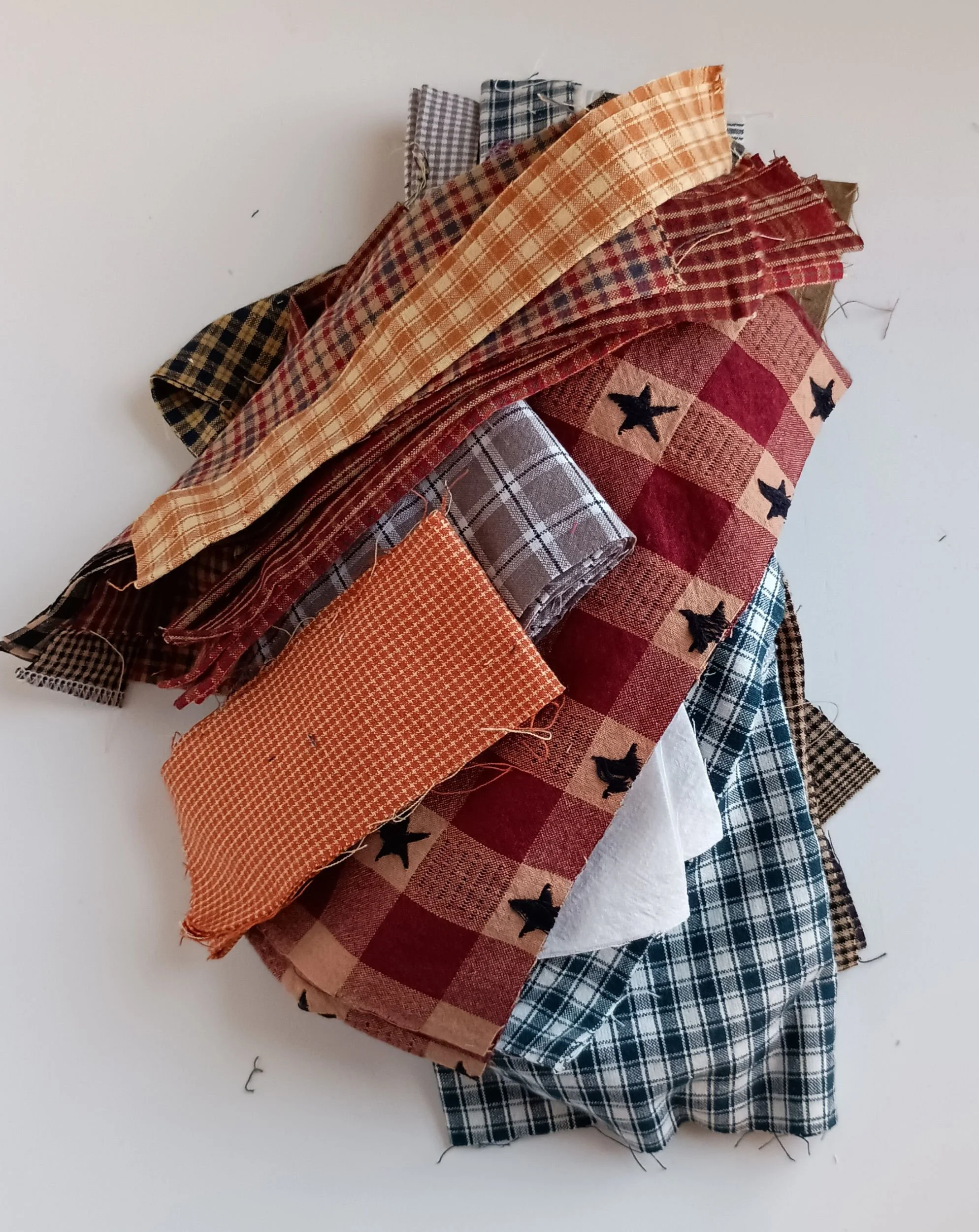 A pile of strips and scraps of homespun fabric
