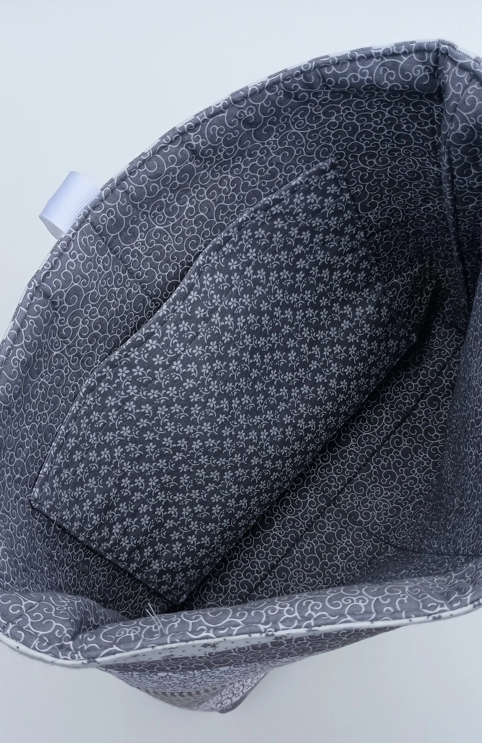 A quilted Bible Sleeve made from gray and white print fabrics