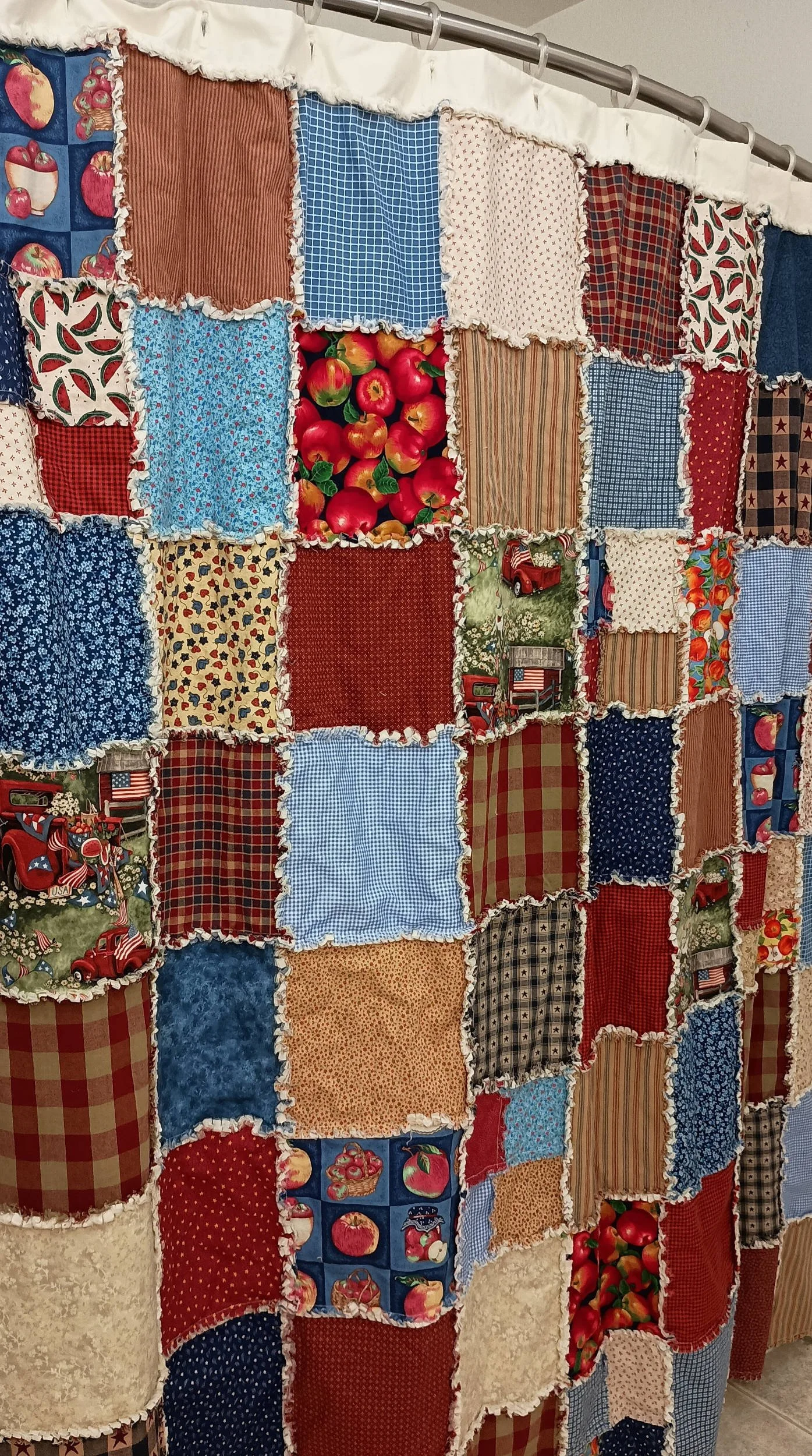 A patchwork shower curtain featuring Americana themed squares and colors