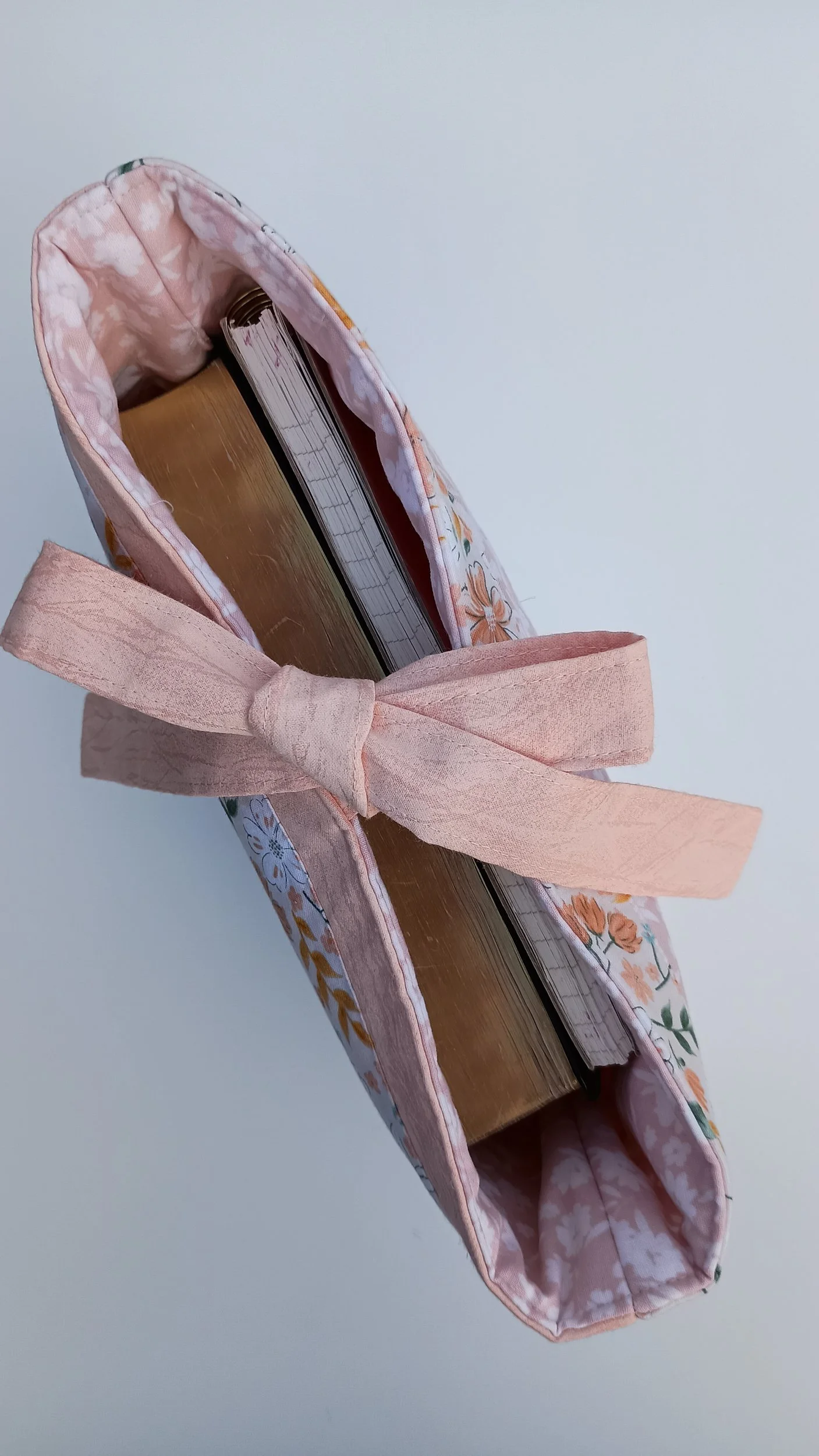 A quilted Bible Sleeve made from peach and blue floral fabrics