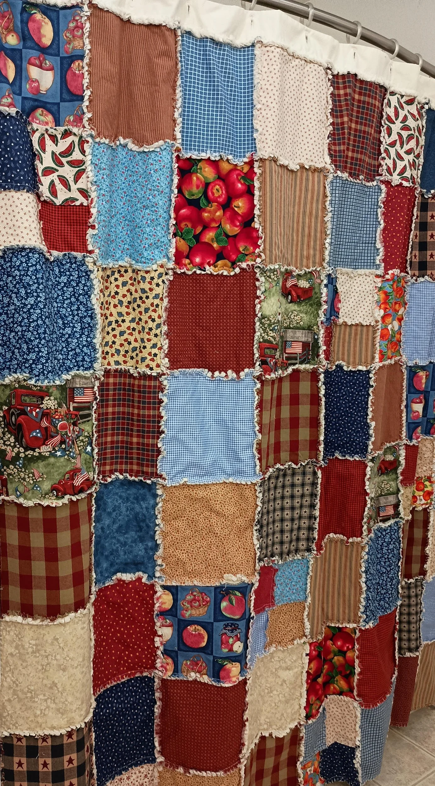 A patchwork shower curtain featuring Americana themed squares and colors