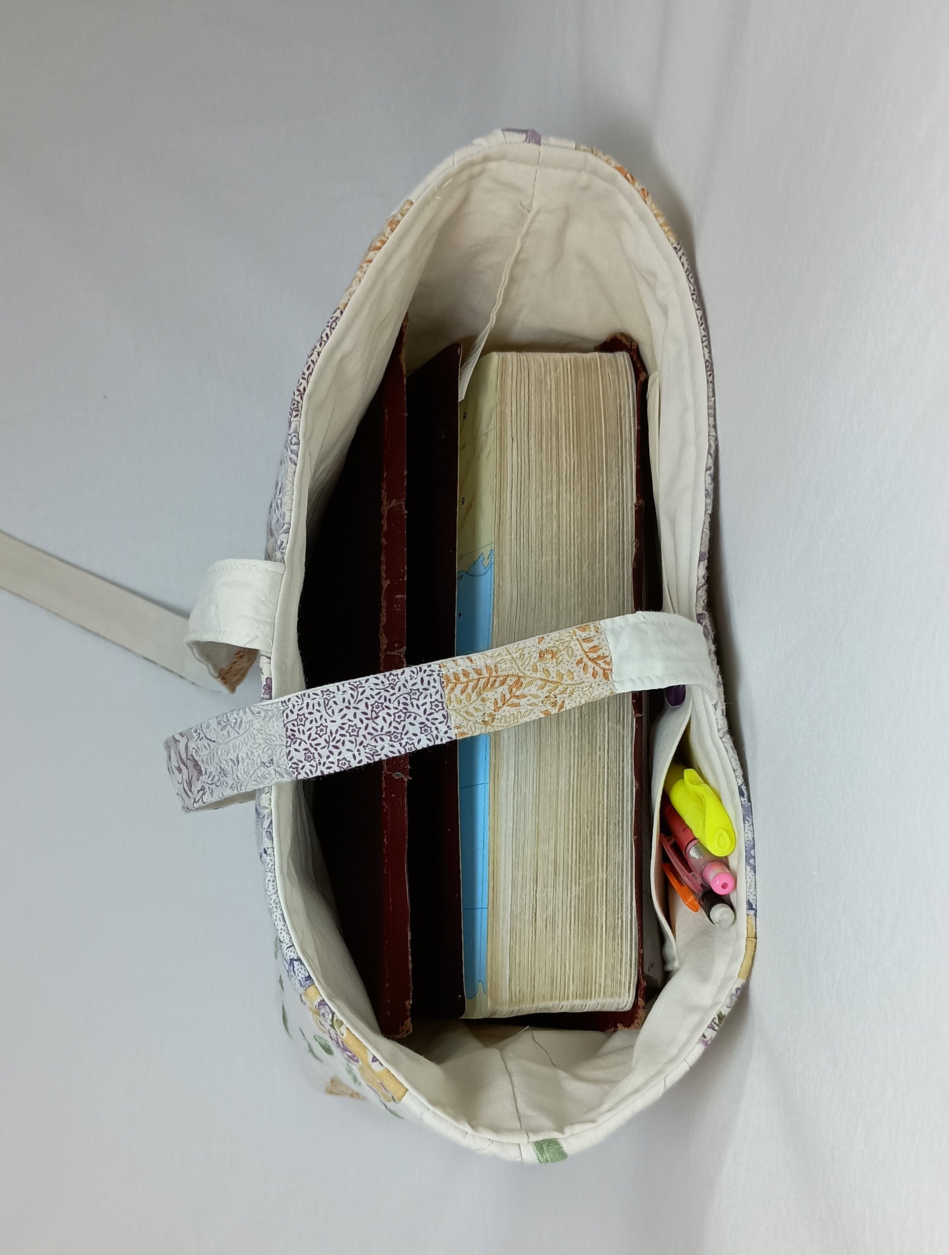 An inside view of an extra large Bible sleeve with Lavender Floral Embroidery made from a vintage quilt