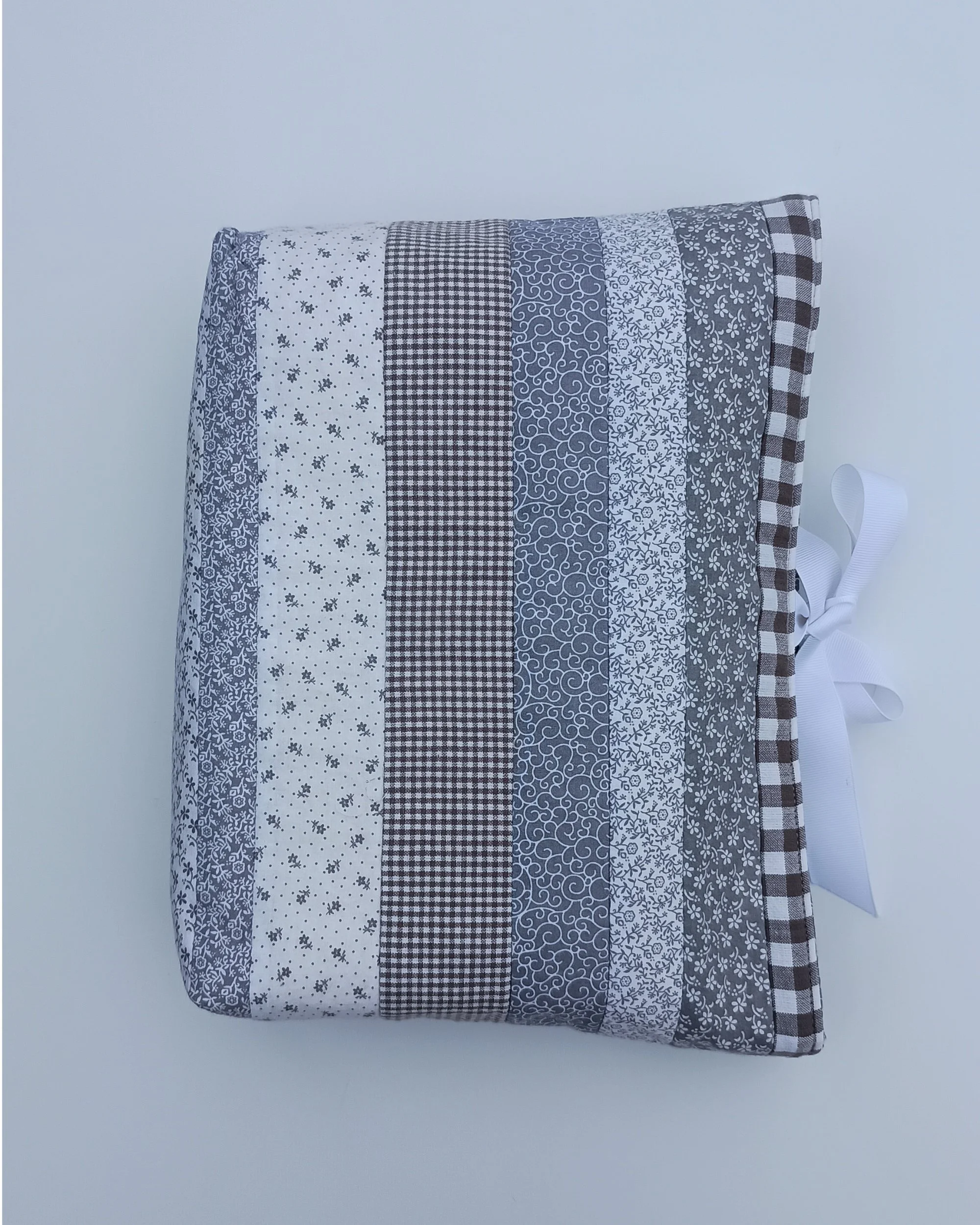A quilted Bible Sleeve made from gray and white print fabrics