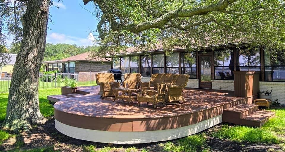Custom 700 sq ft Timbertech Deck addition including an 18' arc (9' Radius). Including some custom box steps, dry bar, skirting, and planter