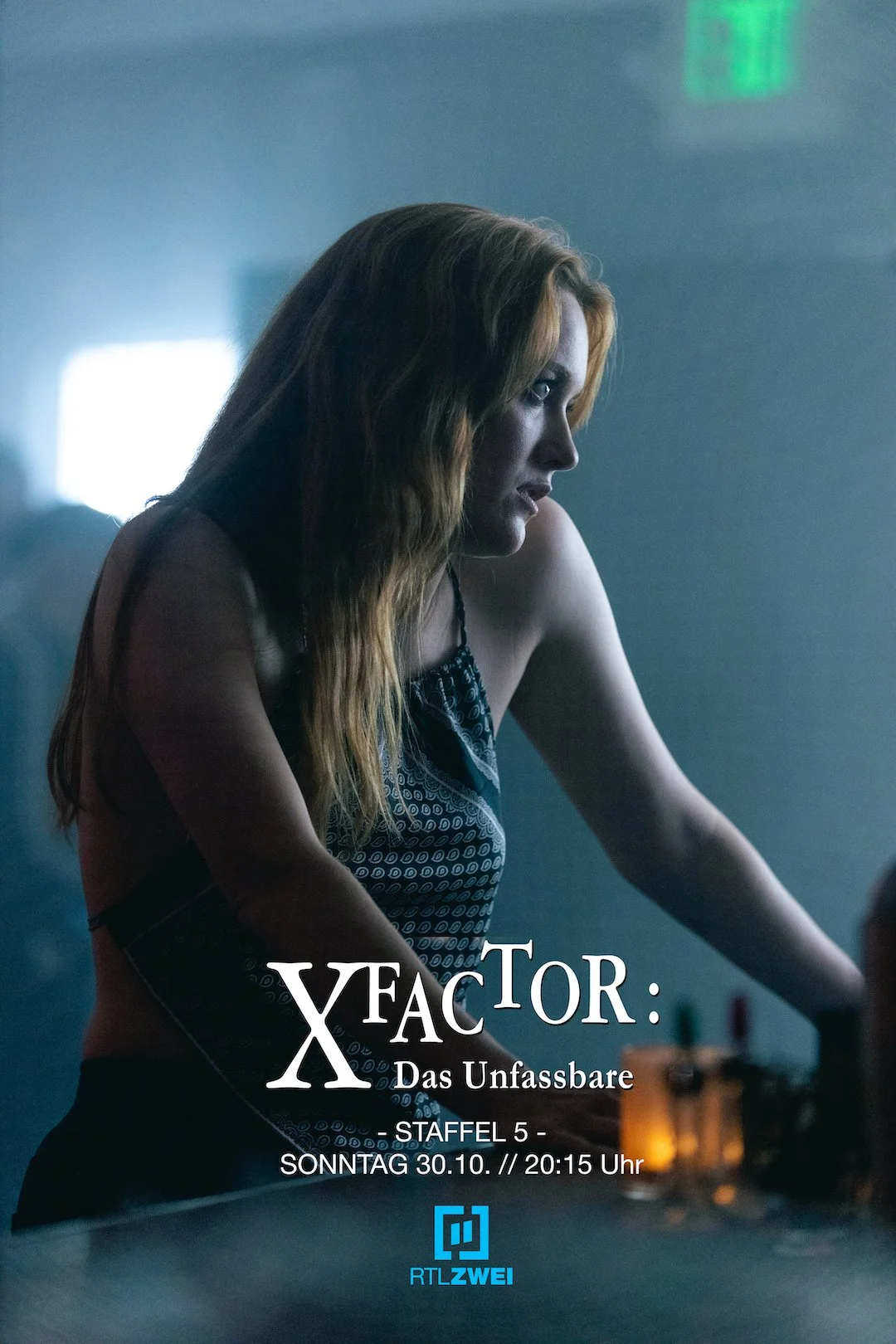 Poster for the TV series X FACTOR: DAS UNFASSBARE. It features a still of a young woman with long wavy hair in a tank top.