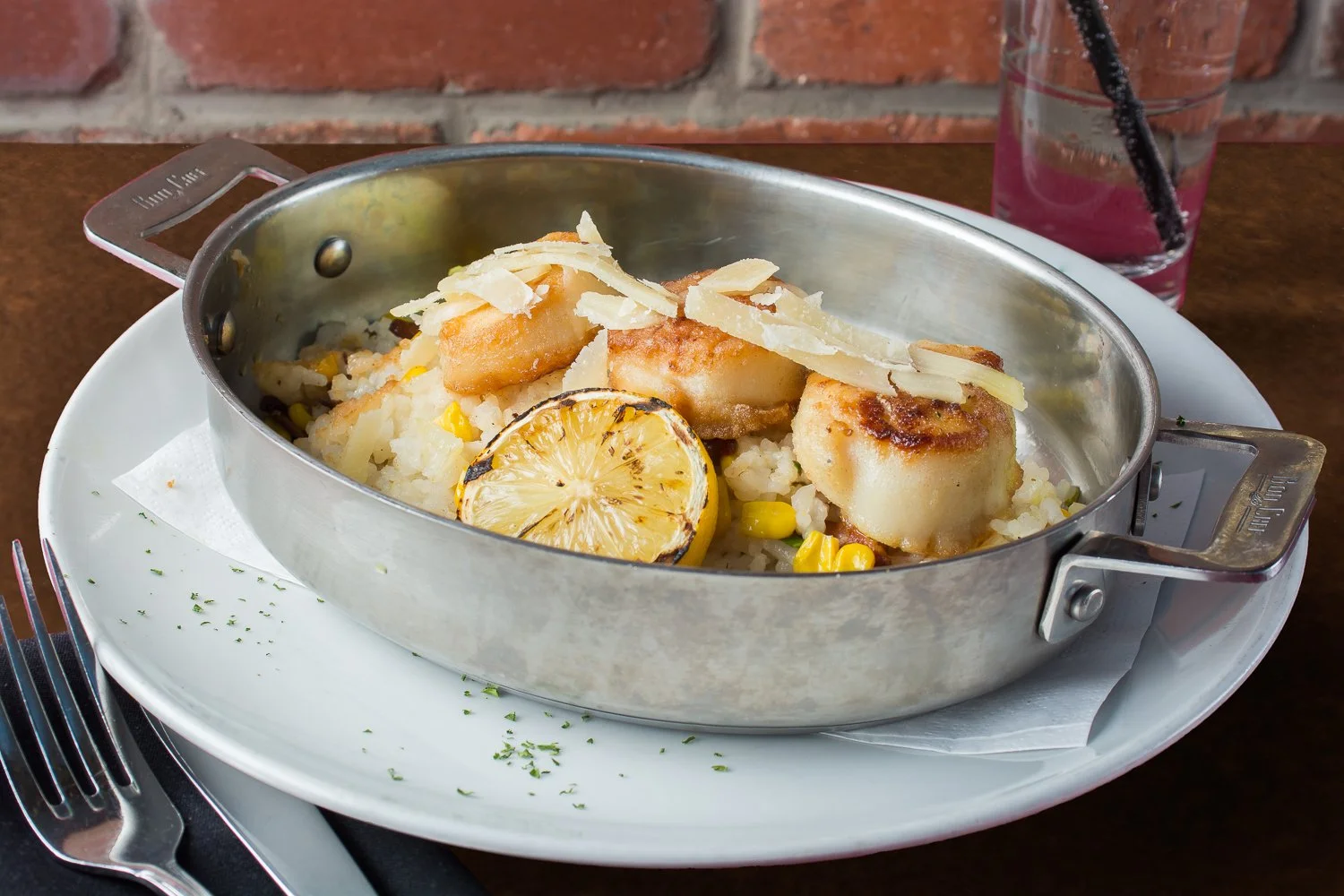 Pan Seared Scallops over rice with corn, and lemon at Metropolitan Cafe in Downtown Freehold, New Jersey