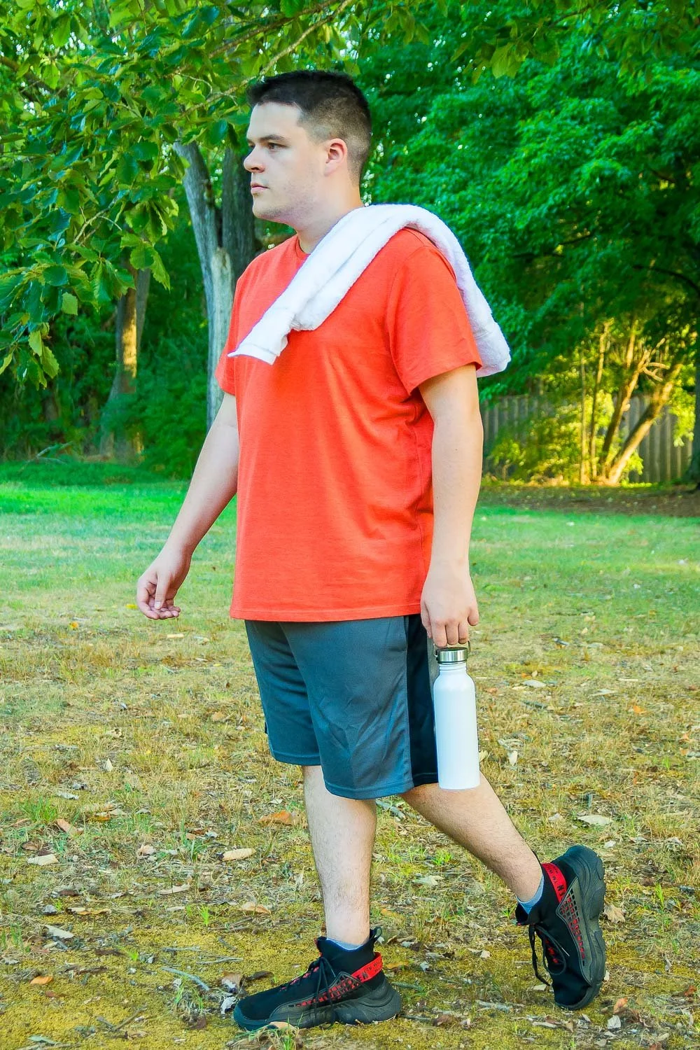 Young male octapharma WILATE patient walking after exercise in a park on a sunny day