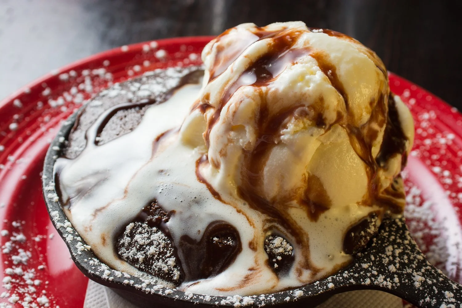 Rosalita's Roadside Cantina Molten Lava Cake topped with Vanilla Ice Cream and chocolate syrup