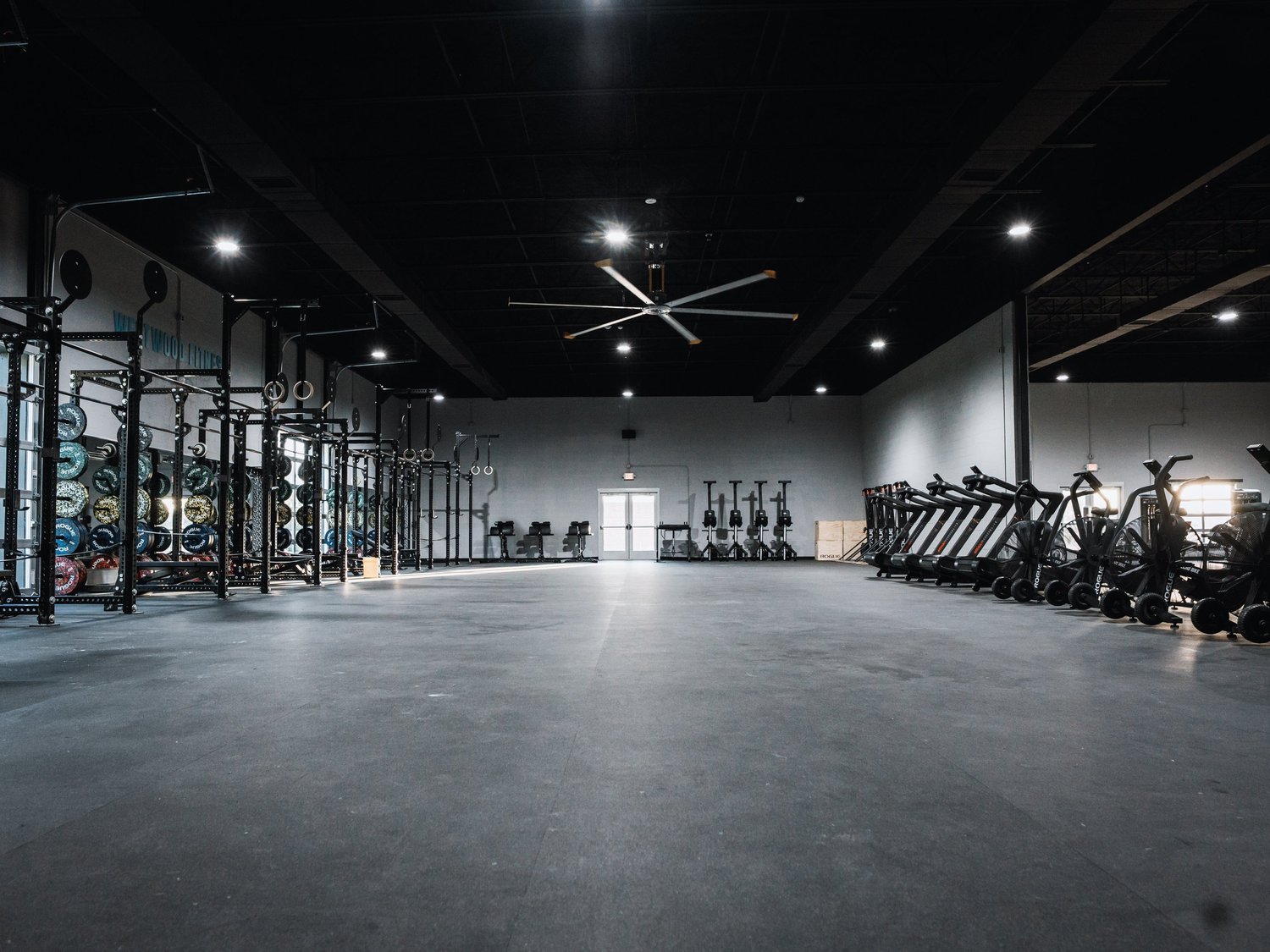 Open gym floor with squat racks and cardio equipment at Westwood Fitness